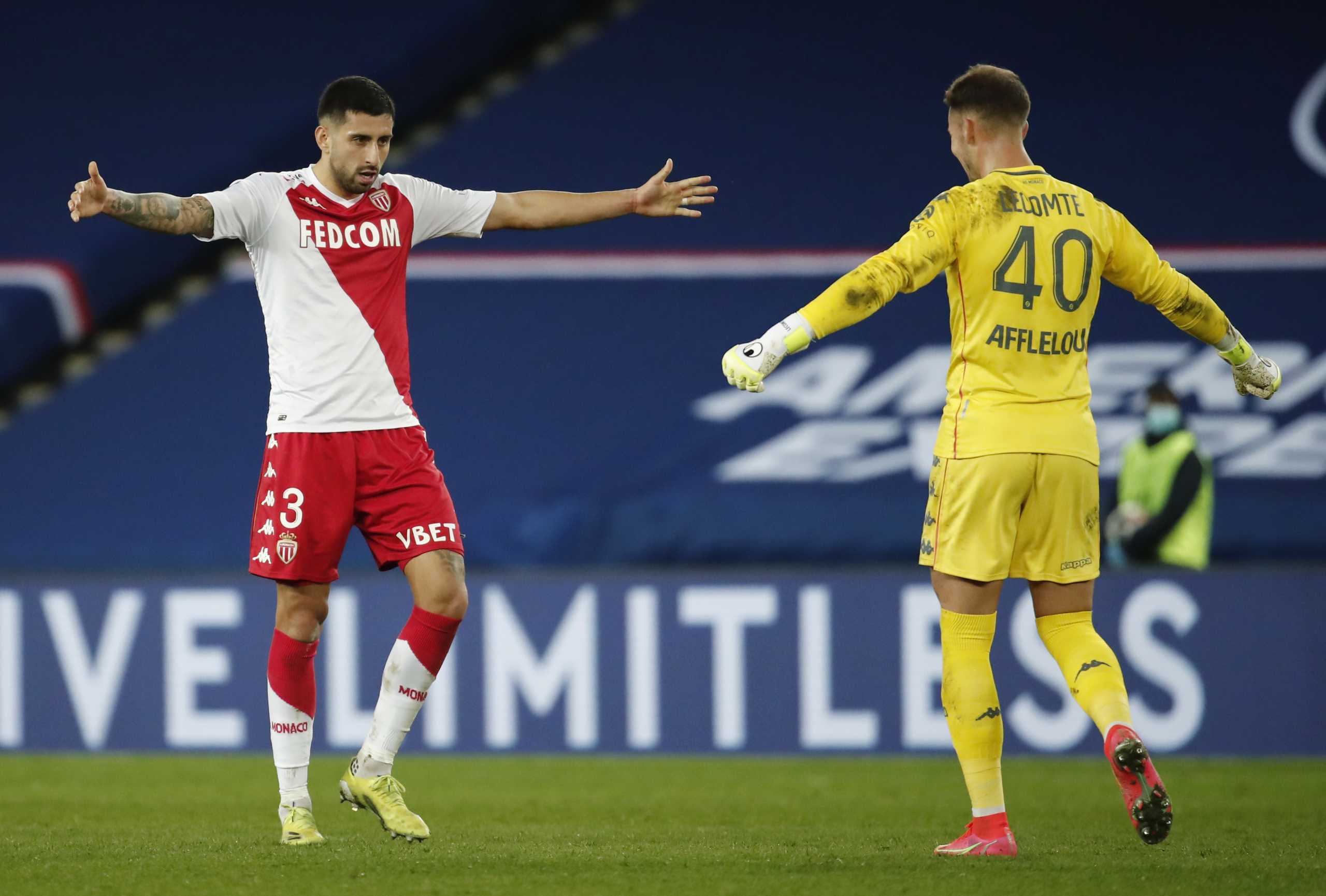 Soccer Football - Ligue 1 - Paris St Germain v AS Monaco - Parc des Princes, Paris, France - February 21, 2021 AS Monaco's Guillermo Maripan and Benjamin Lecomte celebrate after the match REUTERS