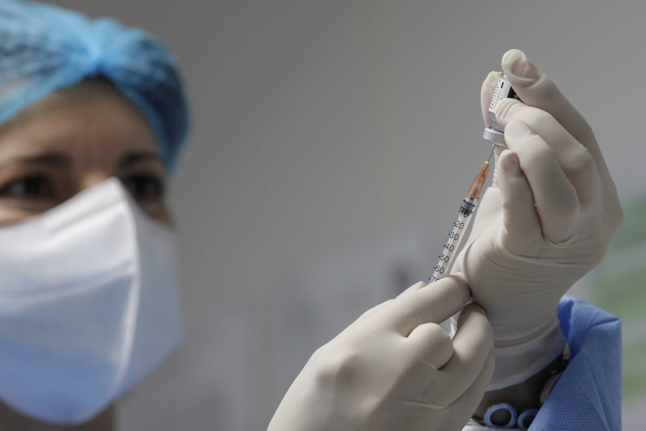 FILE PHOTO: A nurse prepares a dose of the Pfizer-BioNTech coronavirus disease (COVID-19) vaccine at Matei Bals Infectious Diseases Institute in Bucharest, Romania, December 27, 2020. Inquam Photos