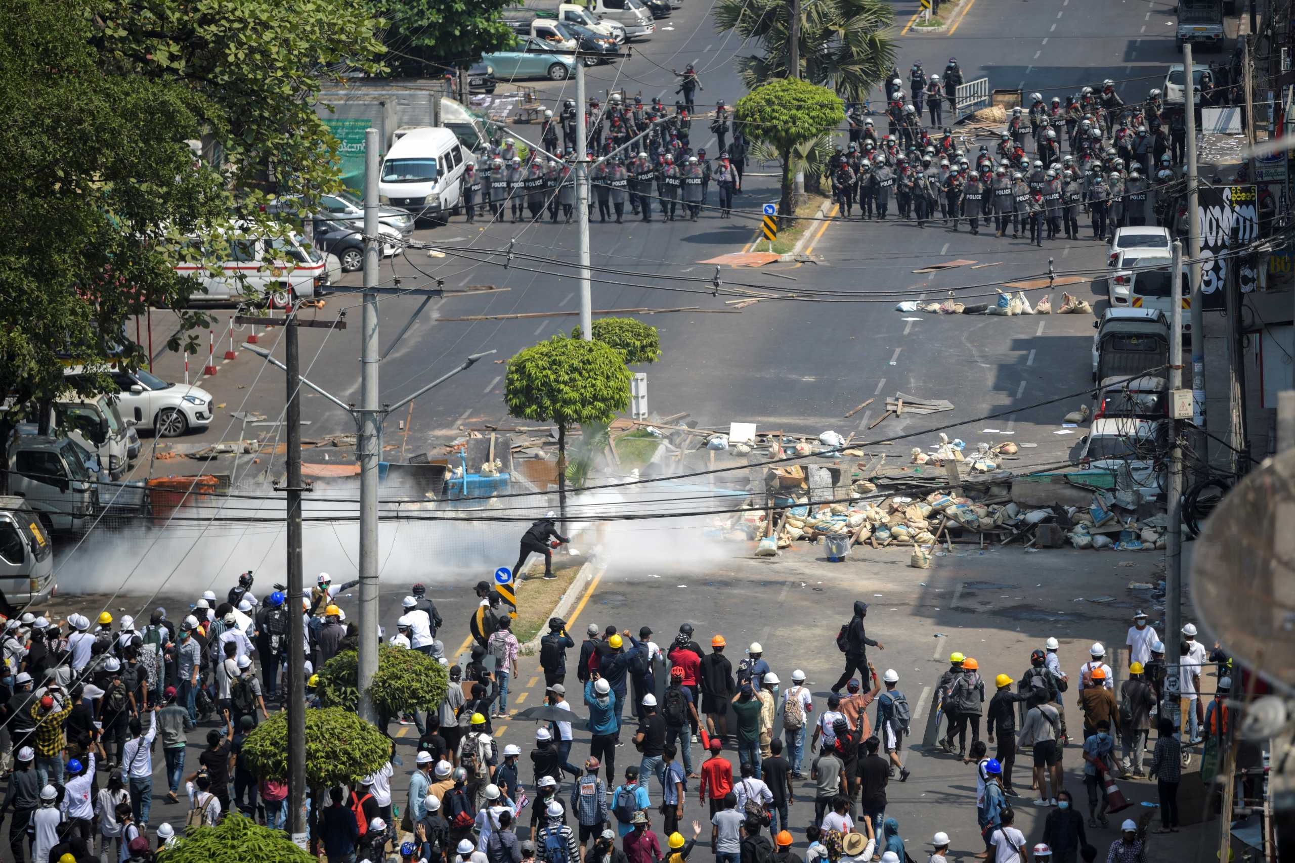 Demonstrators clash with riot police officers during a protest against the military coup in Yangon, Myanmar, February 28, 2021. REUTERS