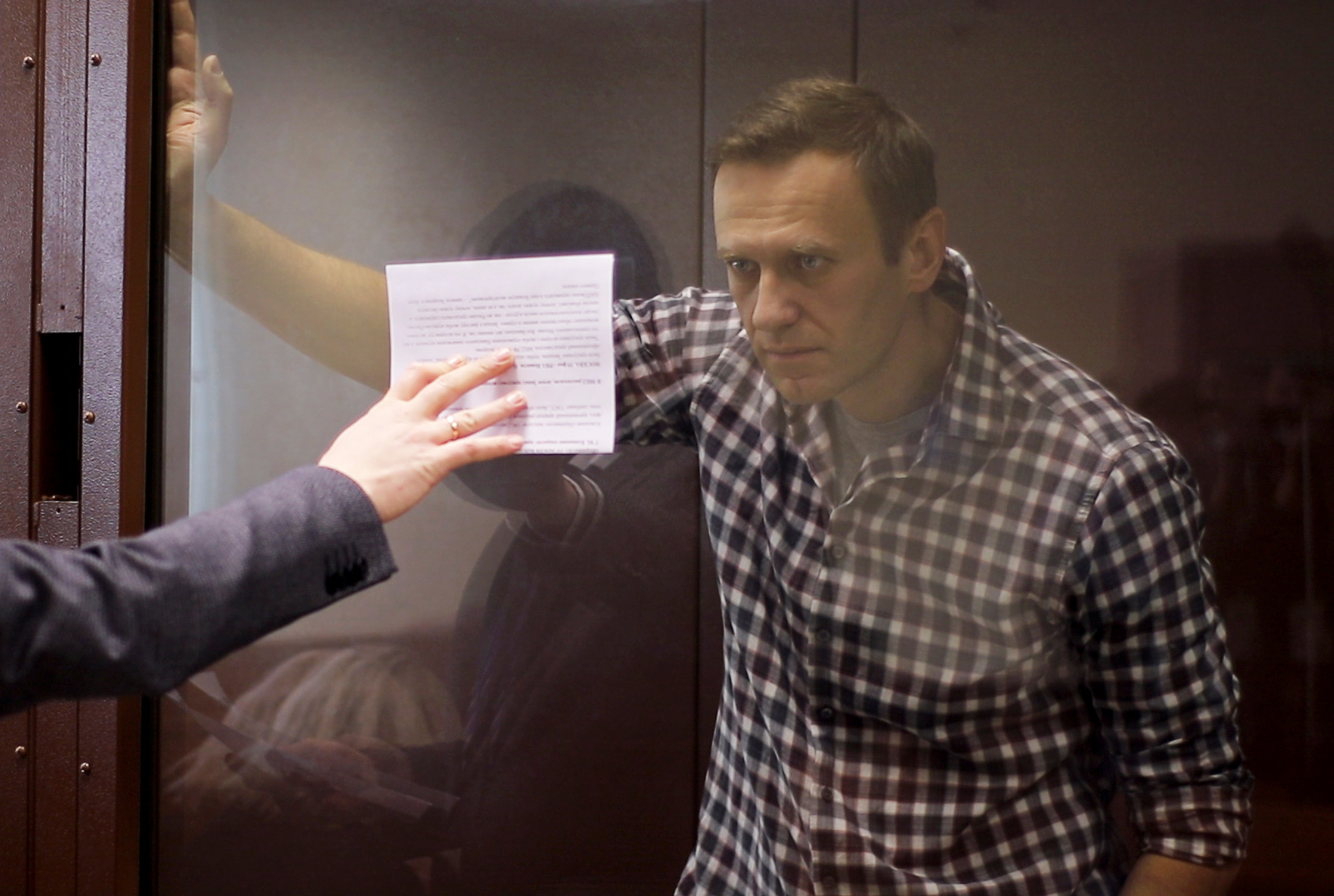 Russian opposition leader Alexei Navalny attends a hearing to consider an appeal against an earlier court decision to change his suspended sentence to a real prison term, in Moscow, Russia February 20, 2021, in this still image taken from video. Press Service of Moscow City Court