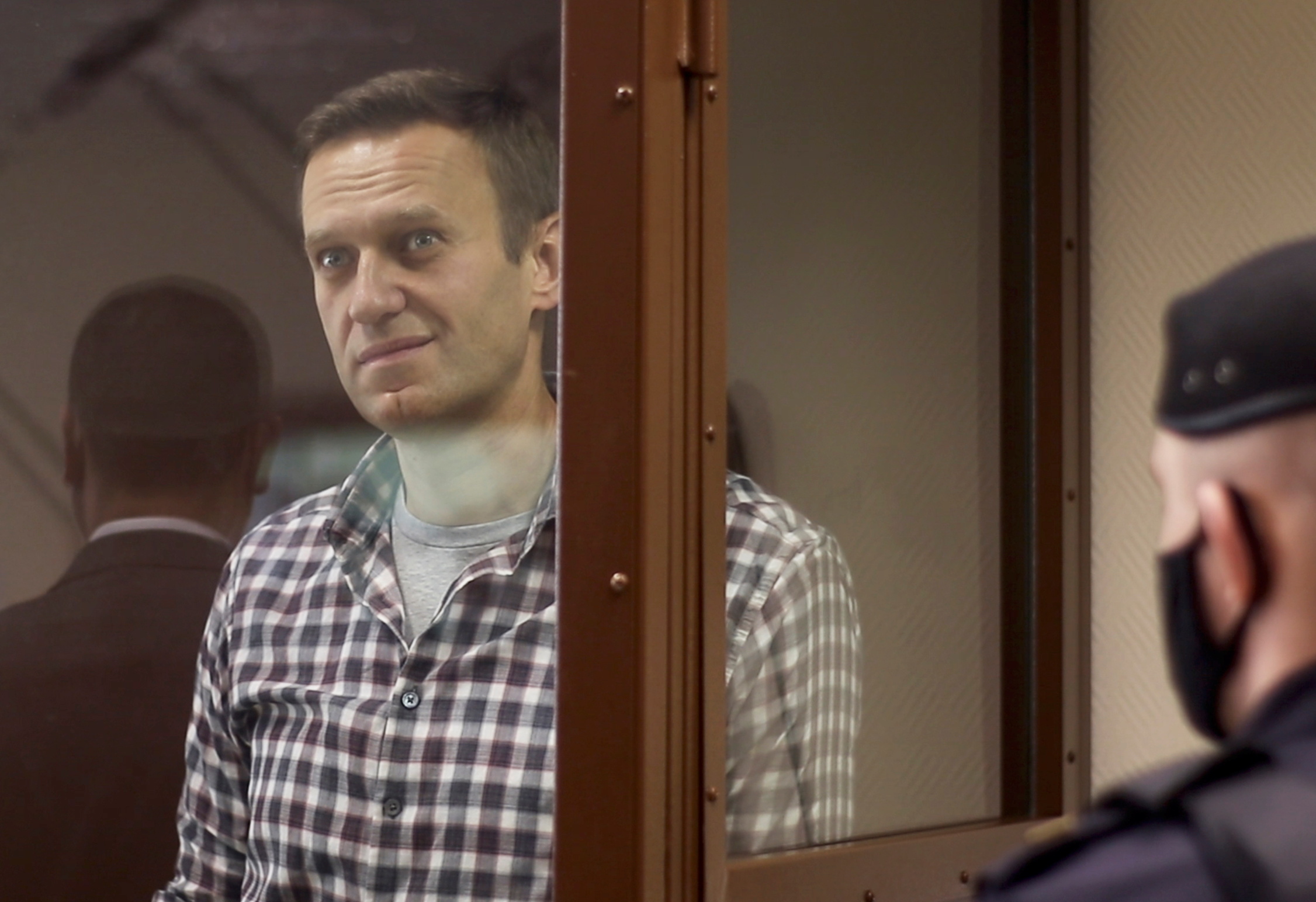 Russian opposition leader Alexei Navalny attends a hearing to consider an appeal against an earlier court decision to change his suspended sentence to a real prison term, in Moscow, Russia February 20, 2021, in this still image taken from video. Press Service of Moscow City Court