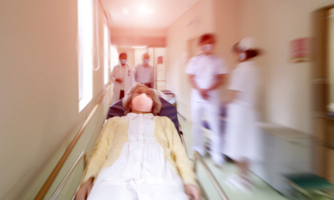 Sick woman on stretcher in the hospital emergency room on pandemic daysIstockalypse Tokyo, Japan