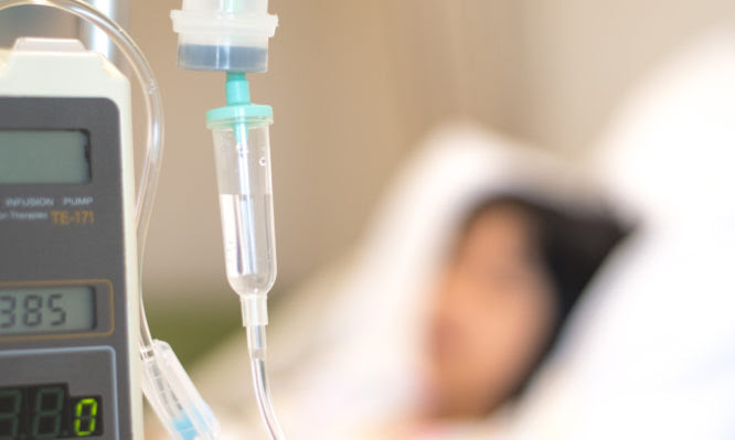 Child patient with IV line in hand sleep on hospital bed. Medical palliation healthcare concept