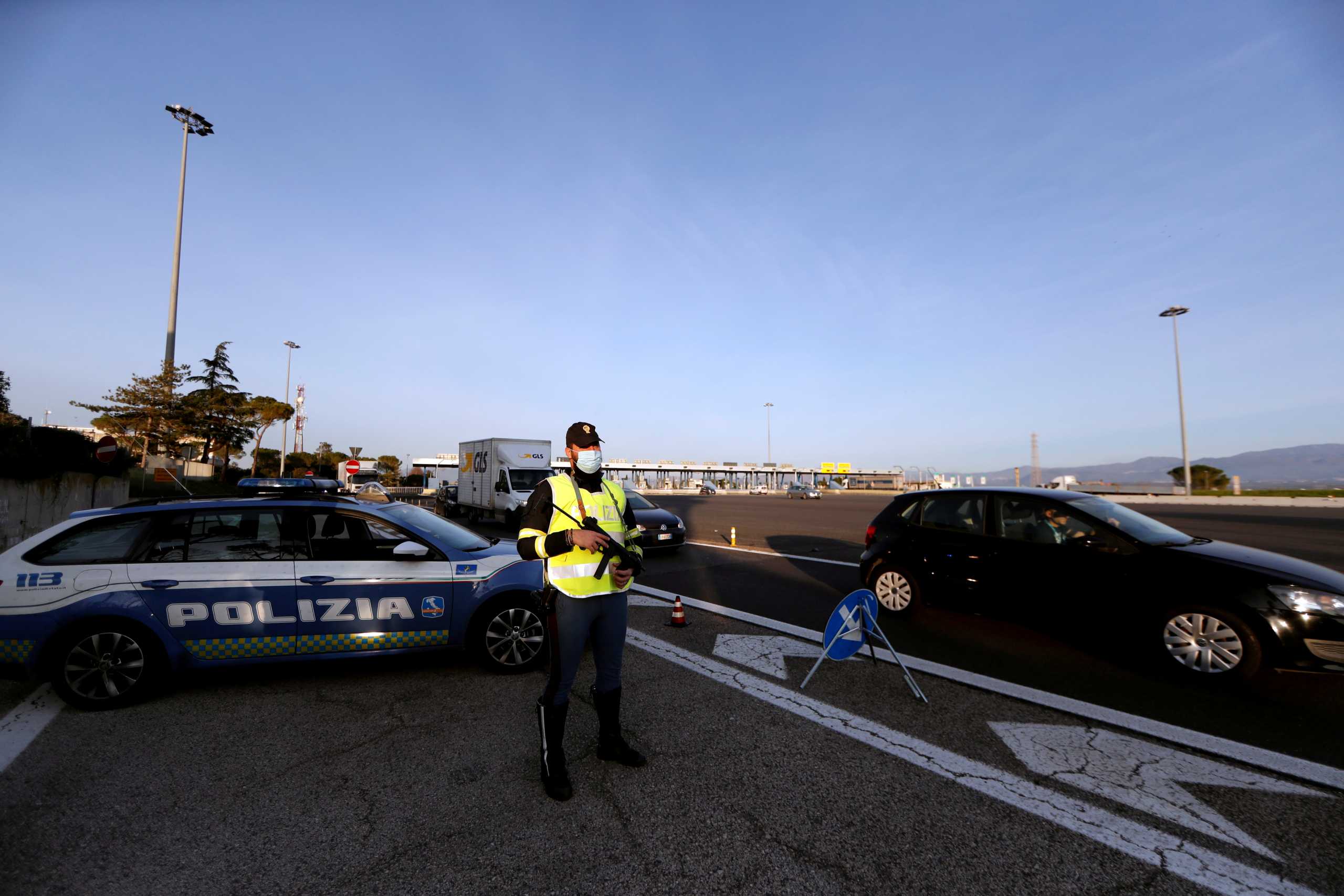 FILE PHOTO: Police officers patrol the motorway after the government ordered Christmas and New Year lockdown, as part of efforts to curb the spread of the coronavirus disease (COVID-19), in Rome, Italy, December 21, 2020. REUTERS