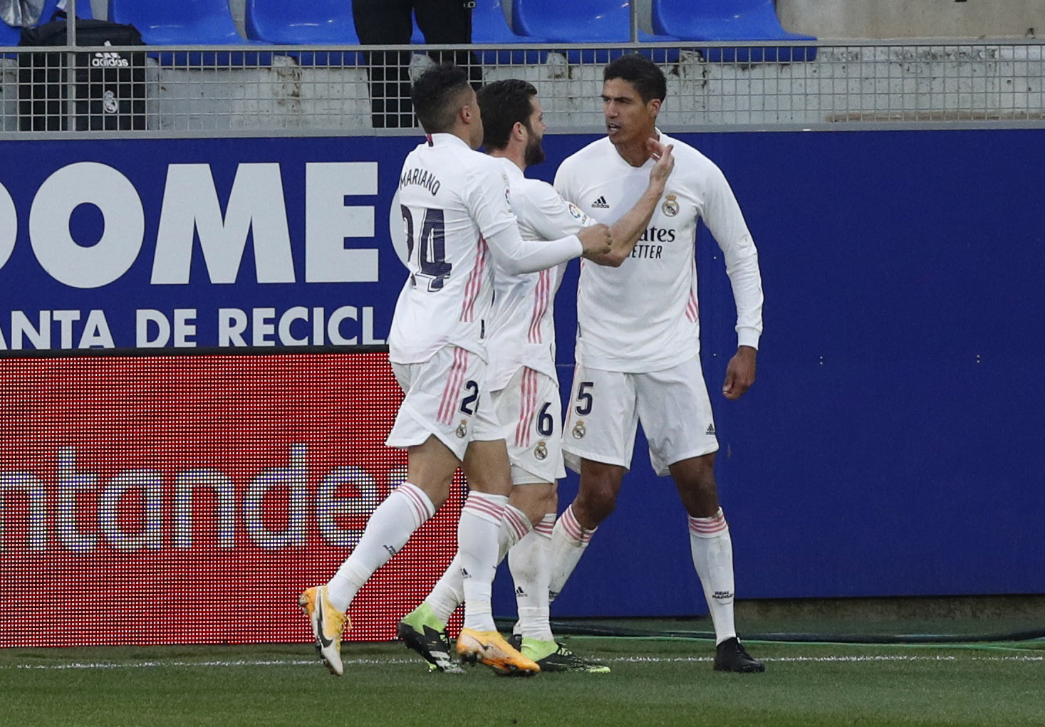 Soccer Football - La Liga Santander - SD Huesca v Real Madrid - Estadio El Alcoraz, Huesca, Spain - February 6, 2021 Real Madrid's Raphael Varane celebrates scoring their second goal with teammates REUTERS