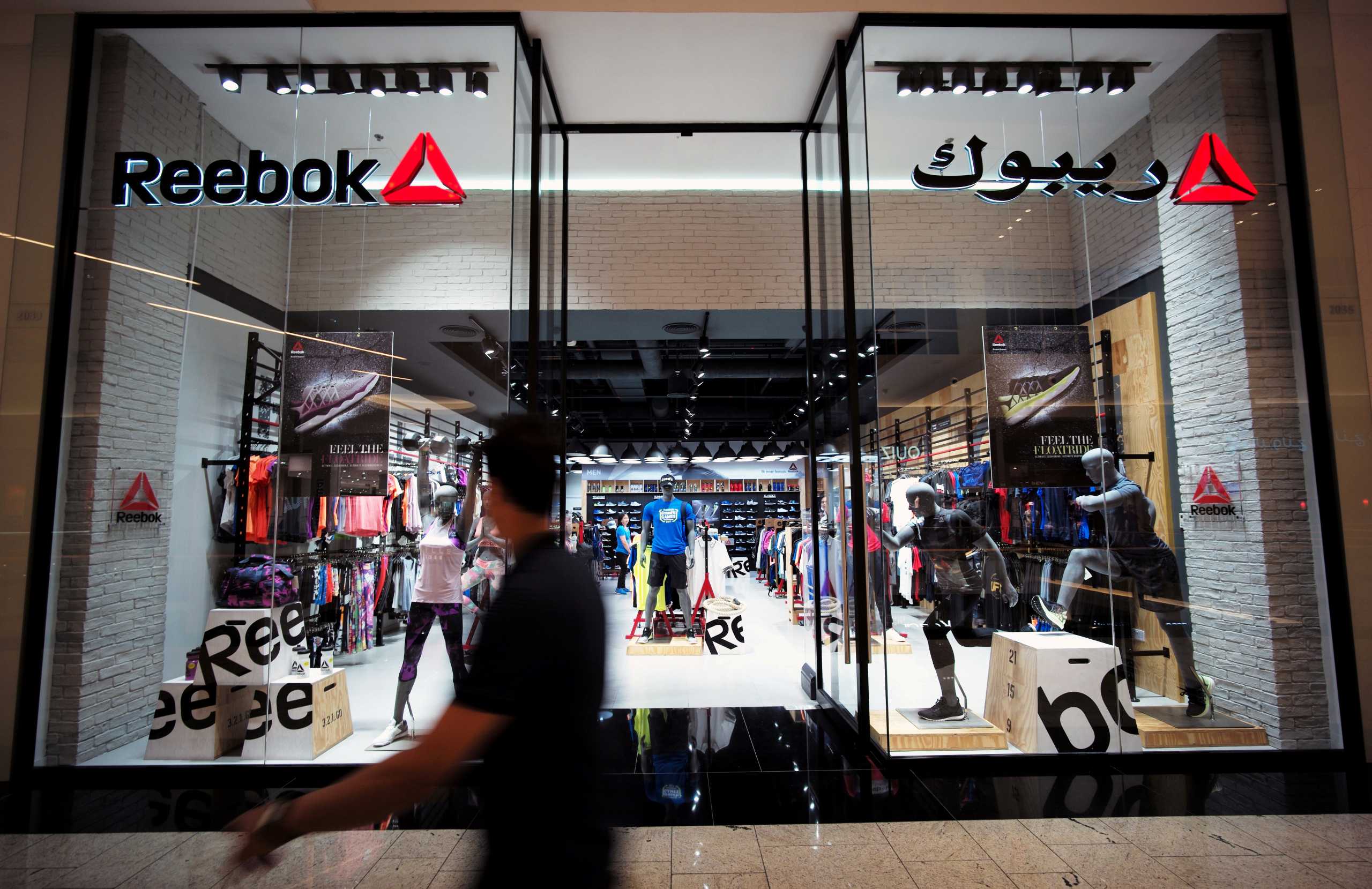 FILE PHOTO: A man walks in front of the Reebok store at Bahrain City Center in Manama, Bahrain September 17, 2017. REUTERS