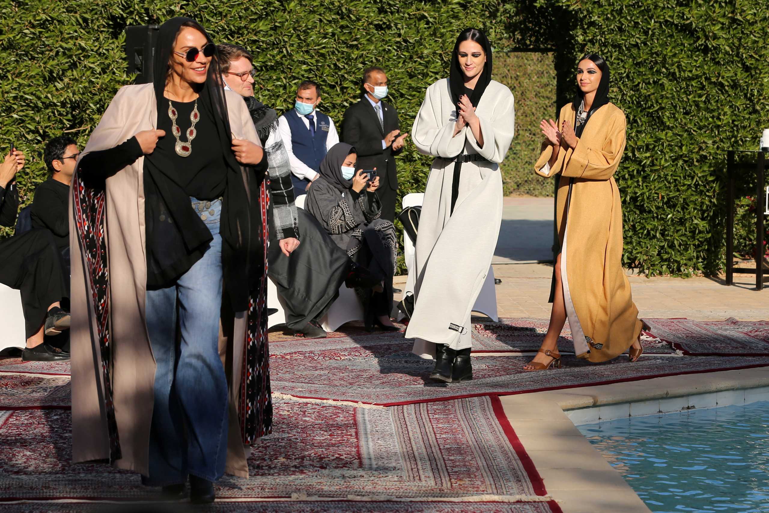 Saudi Princess Safia Hussain walks with Saudi models during a fashion show of her latest collection of abayas (Arabic female dresses), in Riyadh, Saudi Arabia, January 23, 2021. REUTERS