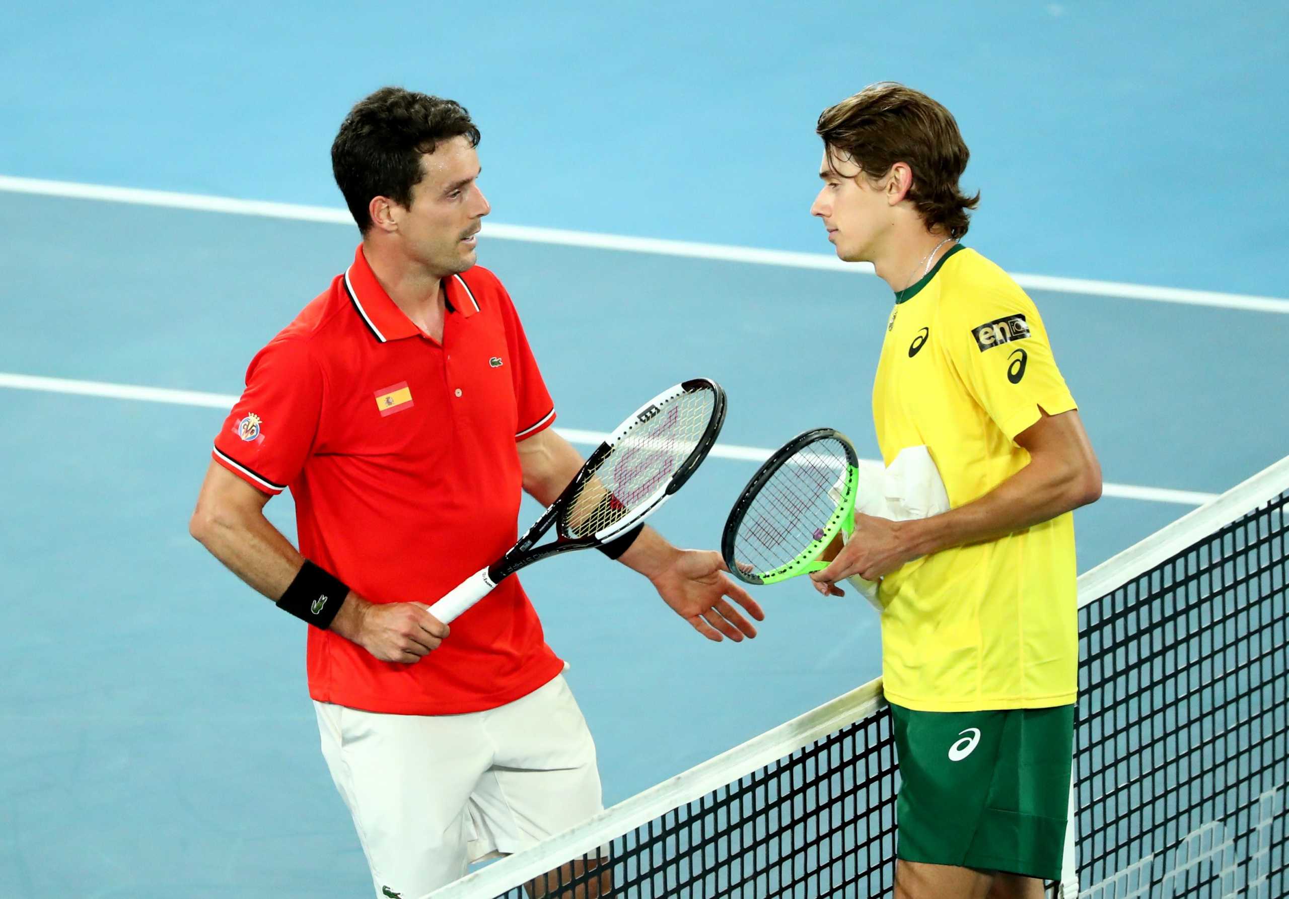 Tennis - ATP Cup - Melbourne Park, Melbourne, Australia, February 2, 2021 Spain's Roberto Bautista Agut with Australia's Alex de Minaur after winning their group stage match REUTERS