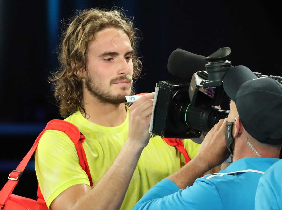 Tennis - Australian Open - Melbourne Park, Melbourne, Australia, February 9, 2021 Greece's Stefanos Tsitsipas signs autographs for fans after winning his first round match against France's Gilles Simon REUTERS