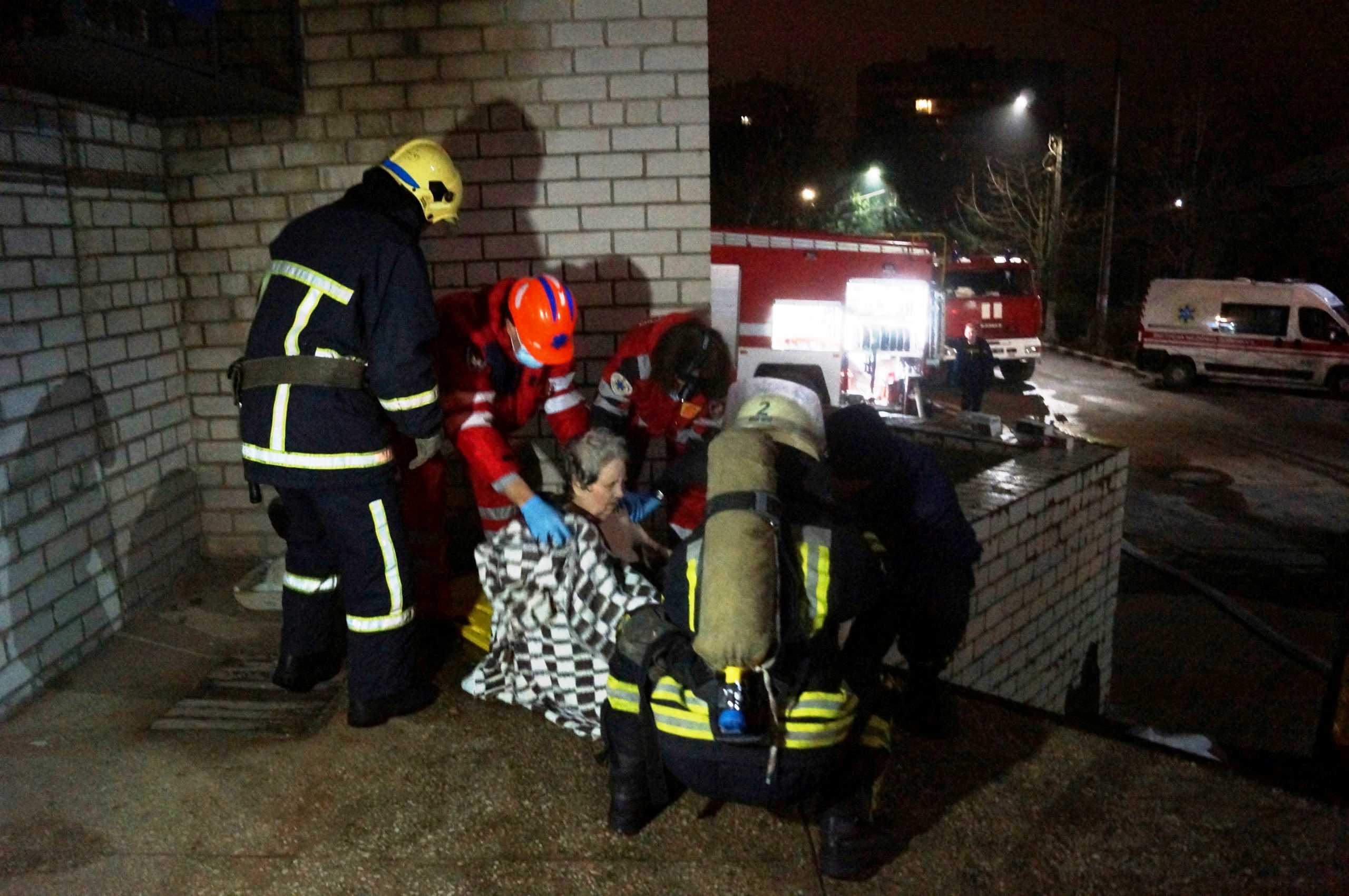 Rescuers and medics evacuate a patient after a fire at a regional hospital for infectious diseases in Zaporizhzhia, Ukraine, in this handout picture released February 4, 2021. State Emergency Service Of Ukraine in Zaporizhzhia region
