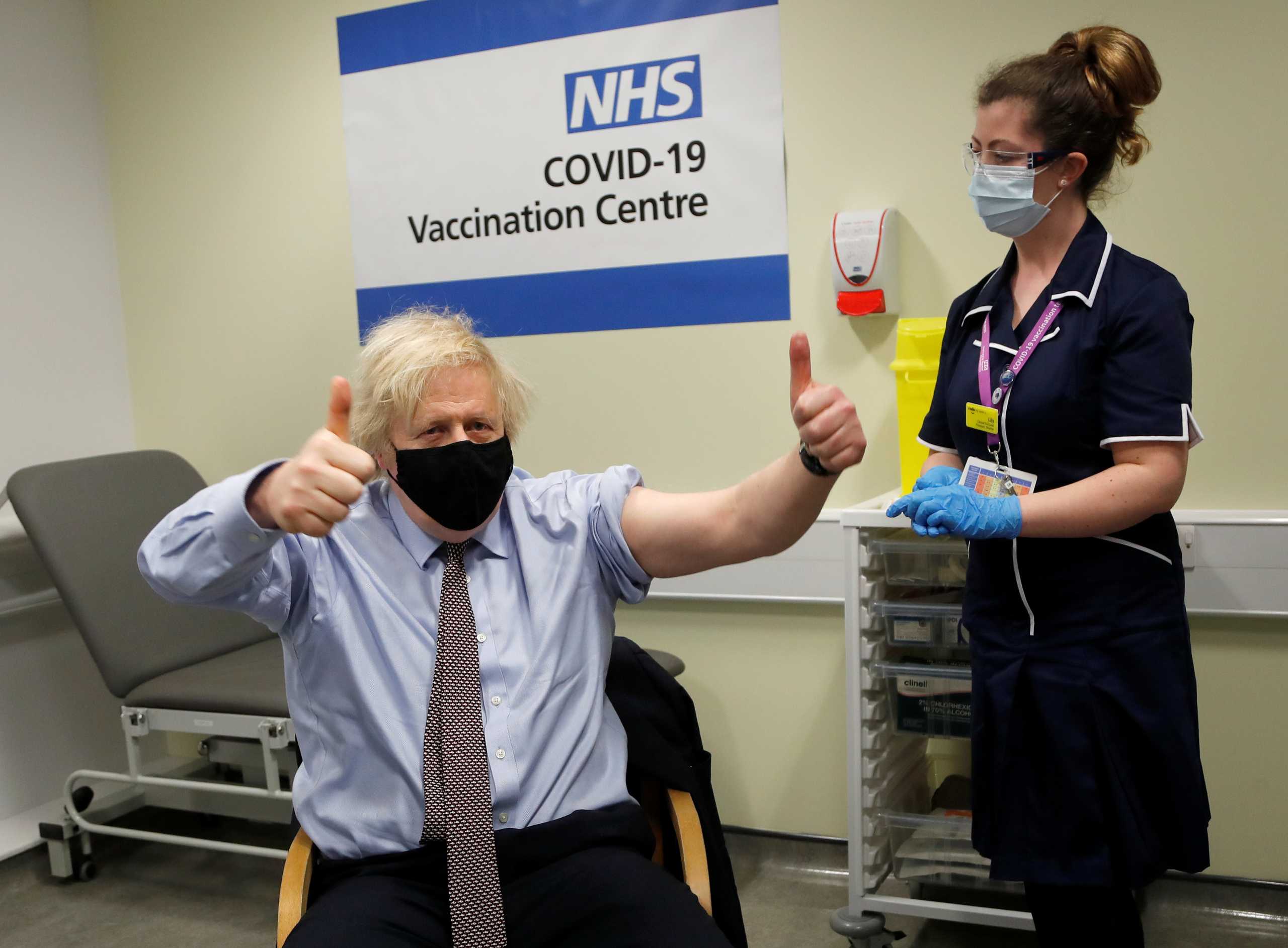 British Prime Minister Boris Johnson reacts after receiving a dose of the Oxford