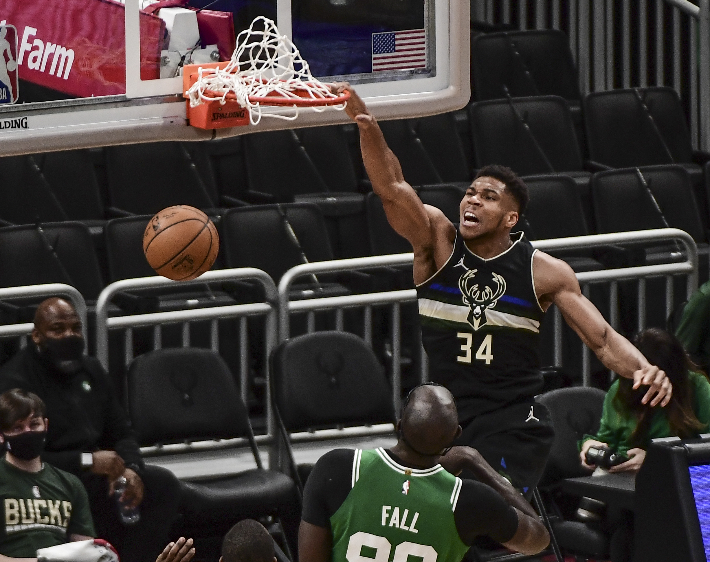 Mar 26, 2021; Milwaukee, Wisconsin, USA; Milwaukee Bucks forward Giannis Antetokounmpo (34) dunks a basket against Boston Celtics center Tacko Fall (99) in the second quarter at Fiserv Forum. Mandatory Credit: Benny Sieu-USA TODAY Sports