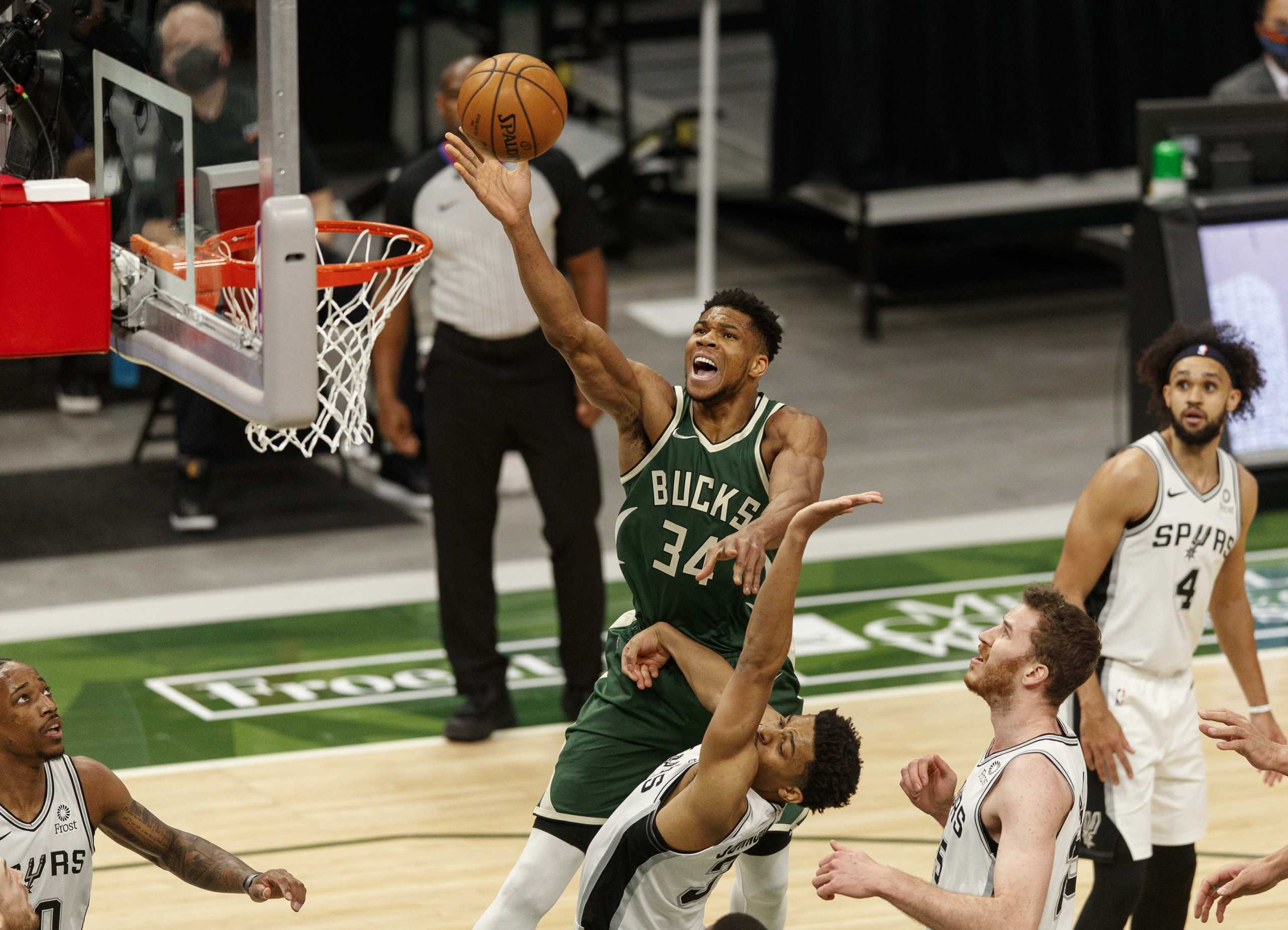 Mar 20, 2021; Milwaukee, Wisconsin, USA;  Milwaukee Bucks forward Giannis Antetokounmpo (34) shoots over San Antonio Spurs guard Keldon Johnson (3) during the first quarter at Fiserv Forum. Mandatory Credit: Jeff Hanisch-USA TODAY Sports