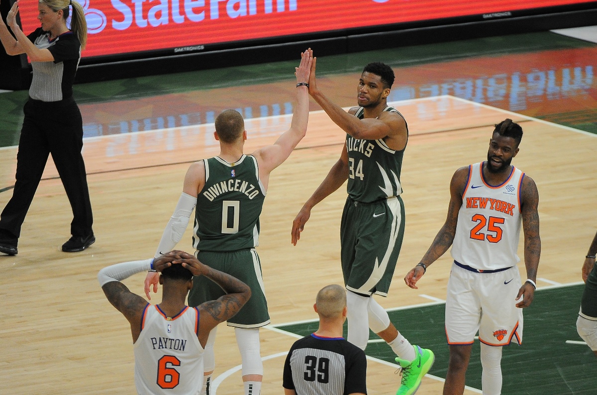 Mar 11, 2021; Milwaukee, Wisconsin, USA;  Milwaukee Bucks forward Giannis Antetokounmpo (34) receives a high-five from guard Donte DiVincenzo (0) after being fouled against the New York Knicks in the second quarter at Fiserv Forum. Mandatory Credit: Michael McLoone-USA TODAY Sports