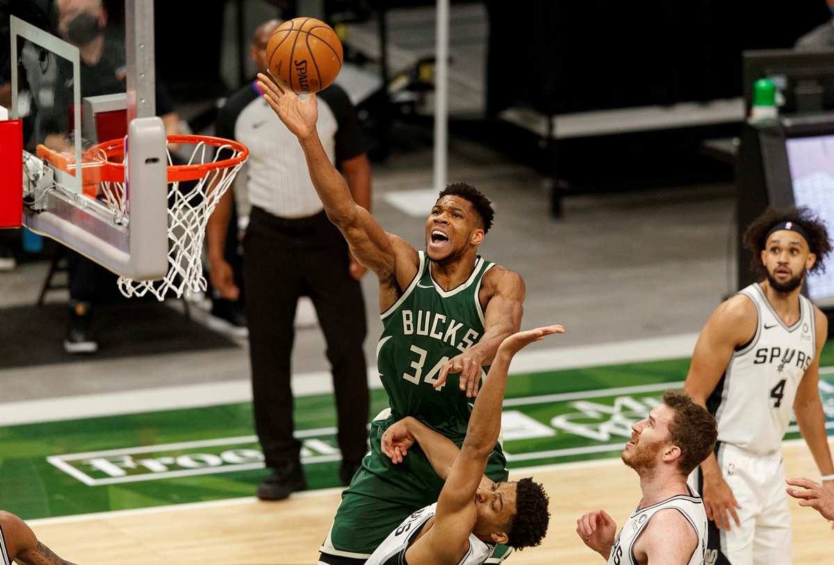 Mar 20, 2021; Milwaukee, Wisconsin, USA;  Milwaukee Bucks forward Giannis Antetokounmpo (34) shoots over San Antonio Spurs guard Keldon Johnson (3) during the first quarter at Fiserv Forum. Mandatory Credit: Jeff Hanisch-USA TODAY Sports