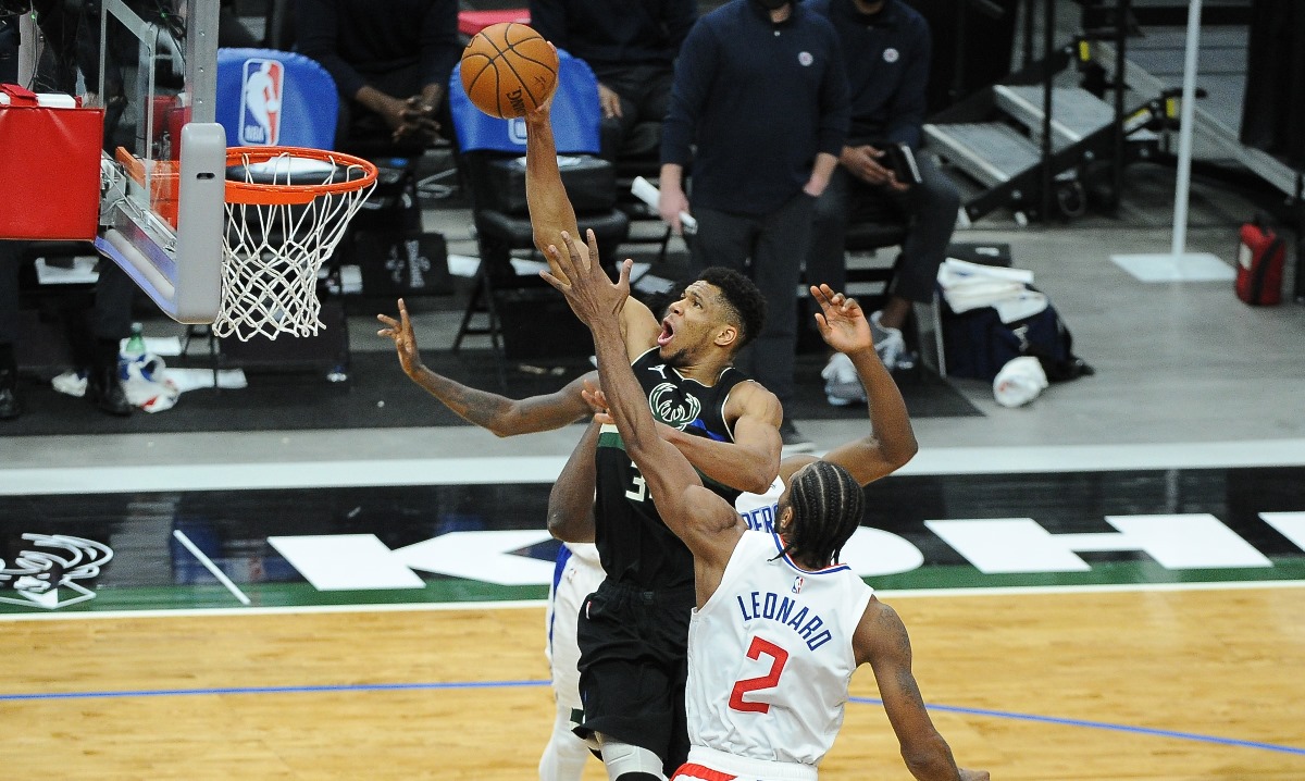 Feb 28, 2021; Milwaukee, Wisconsin, USA; Milwaukee Bucks forward Giannis Antetokounmpo (34) goes to the basket between LA Clippers center Serge Ibaka (9) and forward Kawhi Leonard (2) in the third quarter at Fiserv Forum. Mandatory Credit: Michael McLoone-USA TODAY Sports
