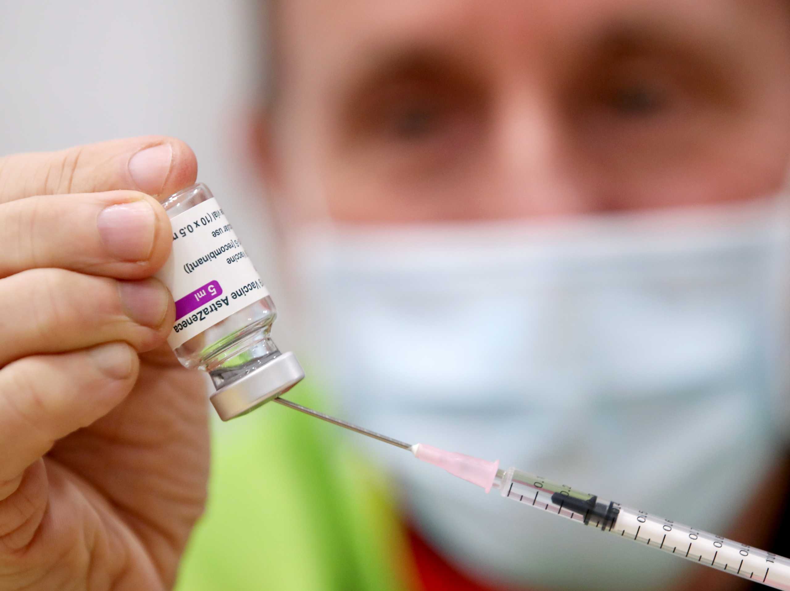 A medical worker prepares a dose of Oxford