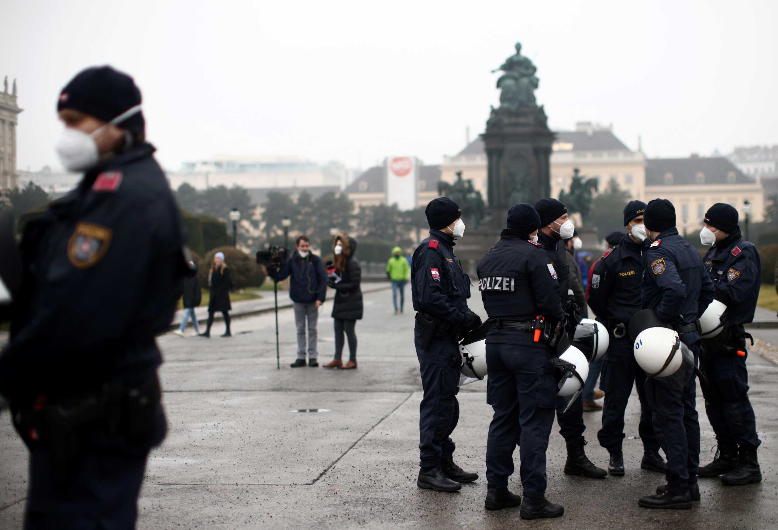 Police officers line up during a demonstration against the coronavirus disease (COVID-19) measures and their economic consequences in Vienna, Austria, February 7, 2021. REUTERS