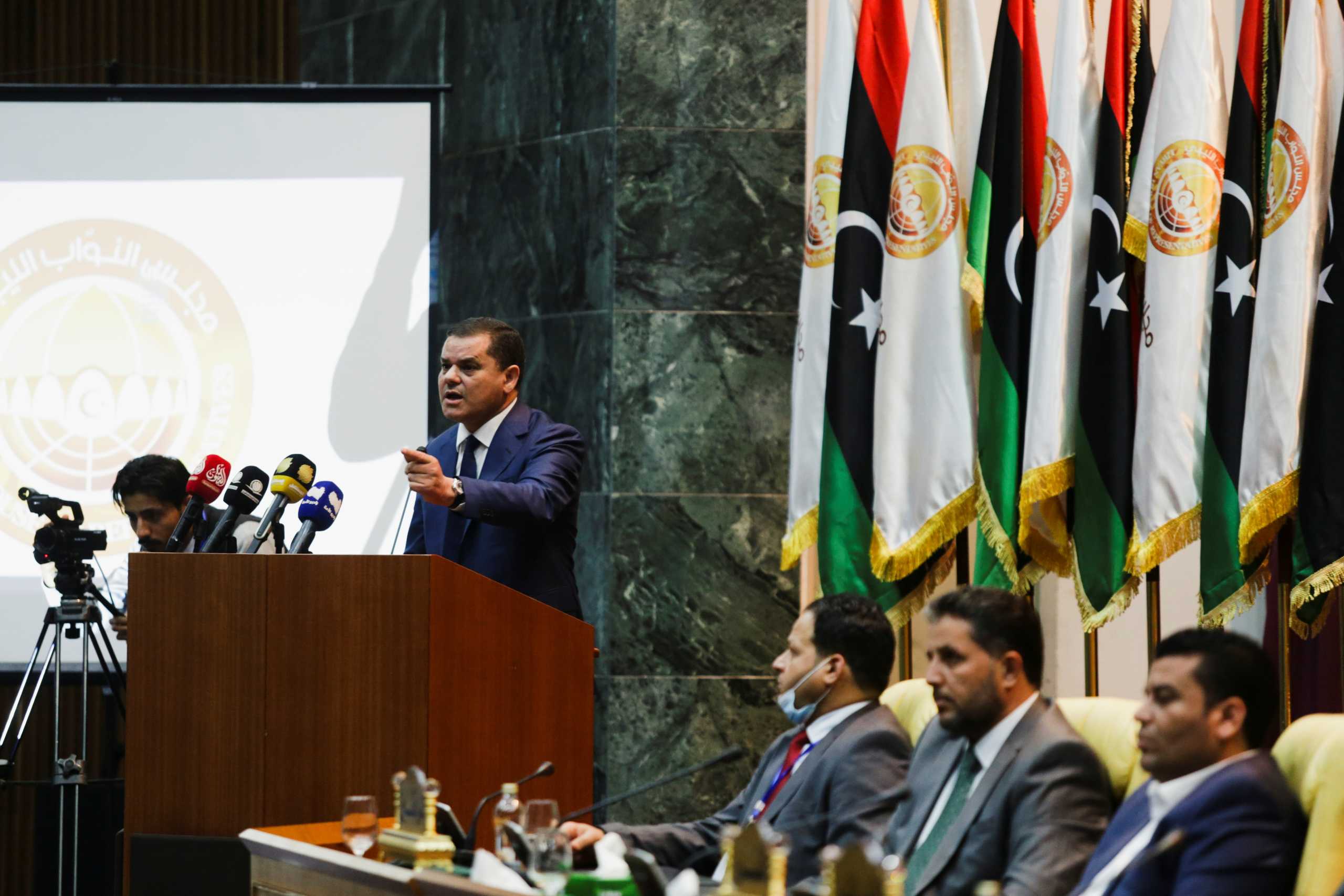 Libya's new Prime Minister Abdulhamid Dbeibeh gestures as he speaks in parliament in Sirte, Libya March 9, 2021. REUTERS