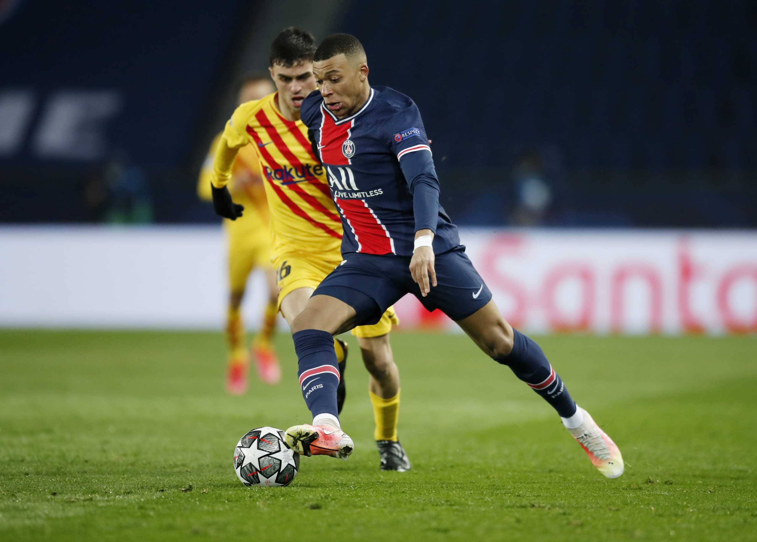 Soccer Football - Champions League - Round of 16 Second Leg - Paris St Germain v FC Barcelona - Parc des Princes, Paris, France - March 10, 2021 Paris St Germain's Kylian Mbappe in action with Barcelona's Pedri REUTERS