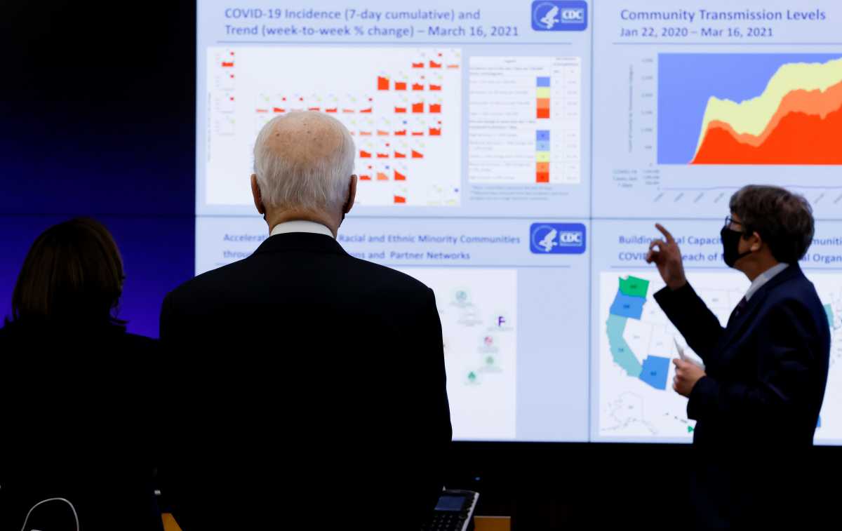 U.S. President Joe Biden and Vice President Kamala Harris view a chart while receiving an update on the fight against the coronavirus disease (COVID-19) pandemic as they visit the Centers for Disease Control and Prevention (CDC) in Atlanta, Georgia, U.S., March 19, 2021. REUTERS