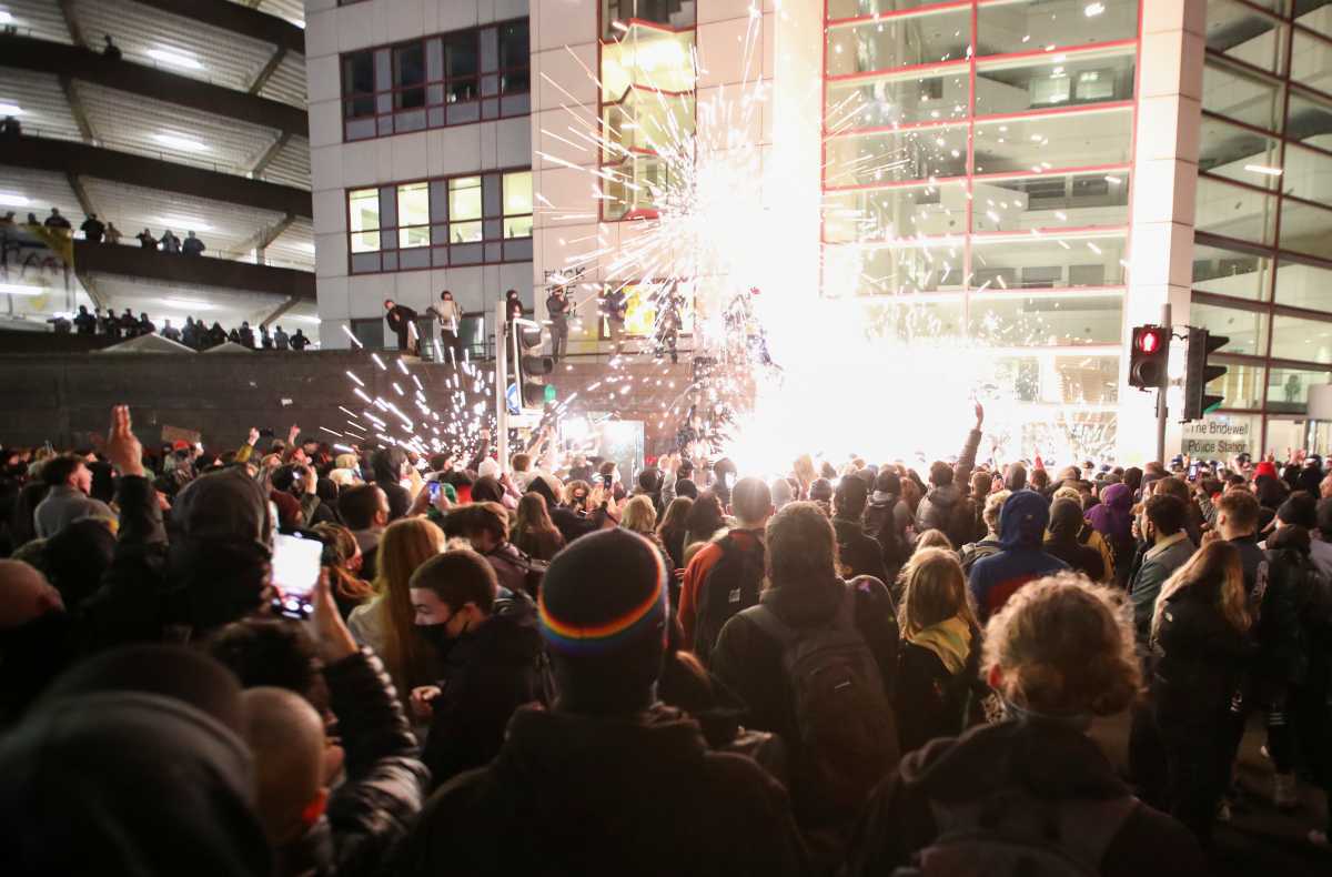Demonstrators launch fireworks at police officers during a protest against a new proposed policing bill, in Bristol, Britain, March 21, 2021. REUTERS