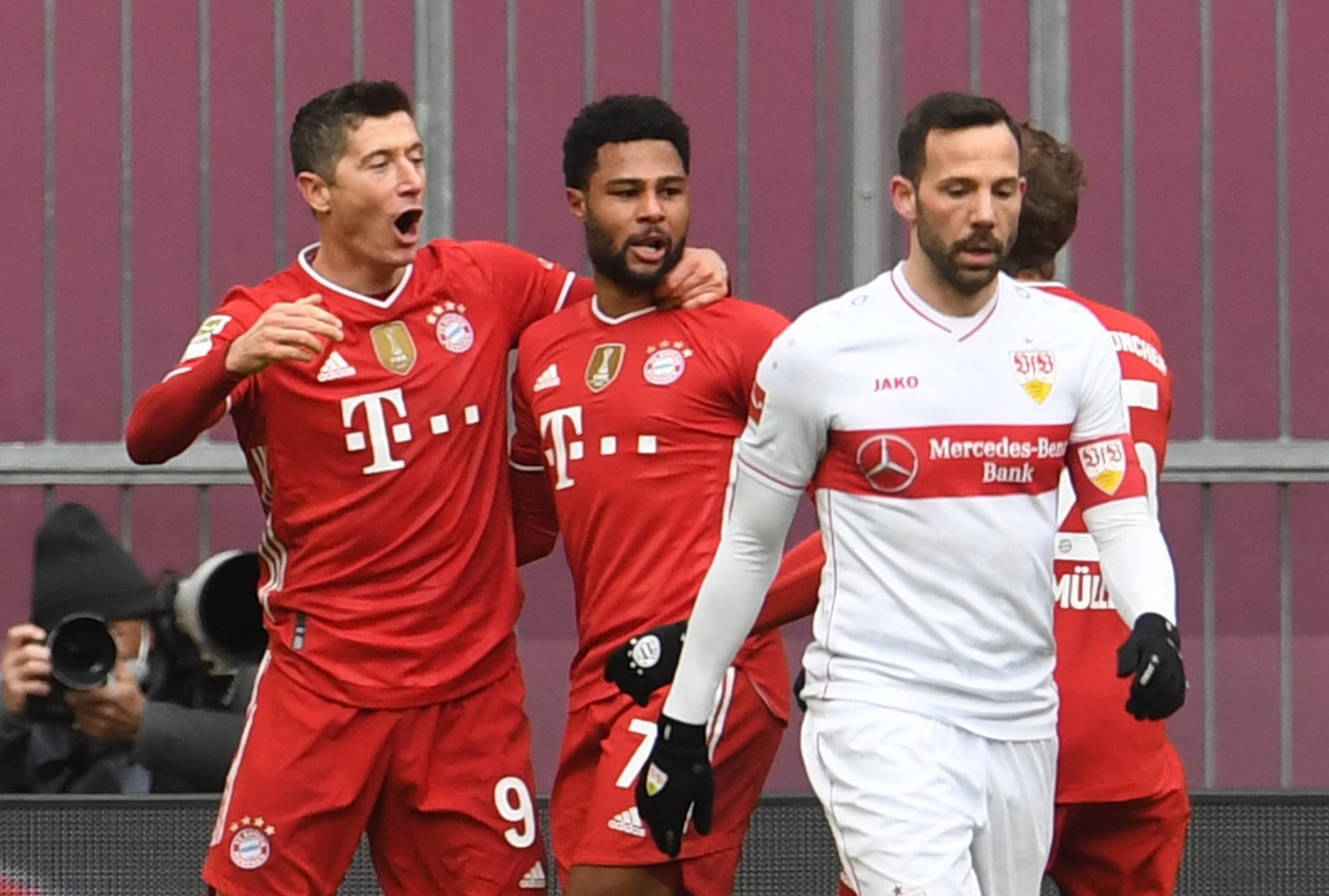 Soccer Football - Bundesliga - Bayern Munich v VfB Stuttgart - Allianz Arena, Munich, Germany - March 20, 2021 Bayern Munich's Robert Lewandowski celebrates scoring their first goal with Serge Gnabry and Thomas Muller as VfB Stuttgart's Gonzalo Castro looks dejected Pool via REUTERS