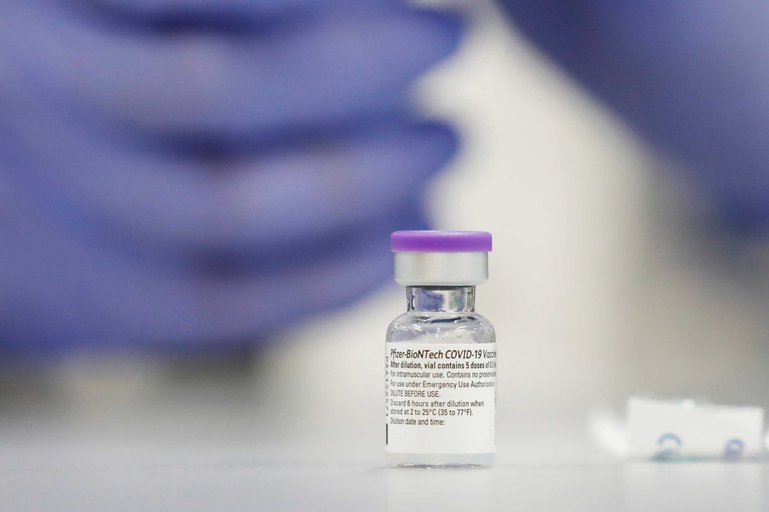 FILE PHOTO: A vial of the Pfizer vaccine against the coronavirus disease (COVID-19) is seen as medical staff are vaccinated at Sheba Medical Center in Ramat Gan, Israel December 19, 2020. Picture taken December 19, 2020. REUTERS