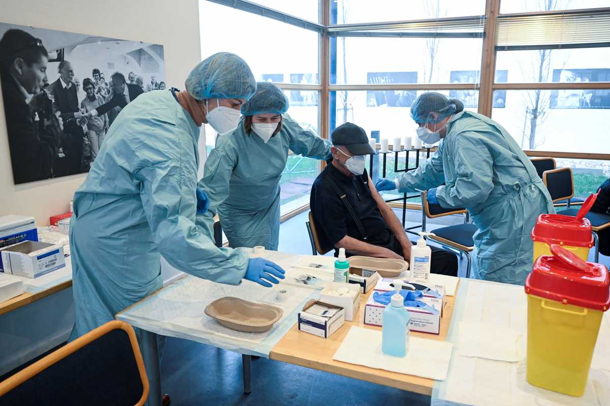 FILE PHOTO: A holocaust survivor receives a dose of a coronavirus disease (COIVD-19) vaccine at Bratislava's Jewish community center, in Bratislava, Slovakia January 27, 2021. REUTERS