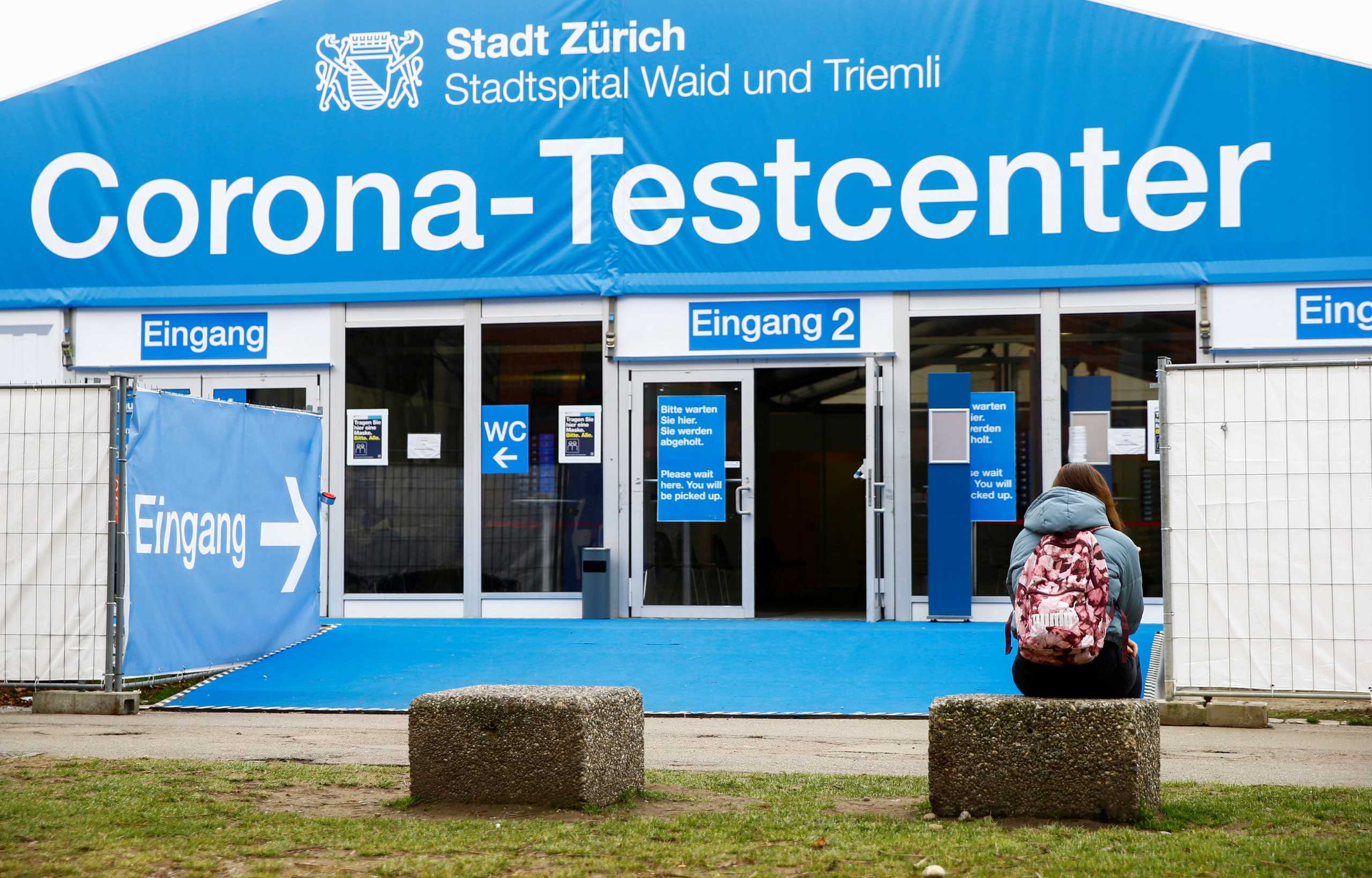 A woman sits in front of a COVID-19 testing site of the Stadtspital Waid and Triemli hospital, as the spread of the coronavirus disease (COVID-19) continues, in Zurich, Switzerland March 3, 2021. REUTERS