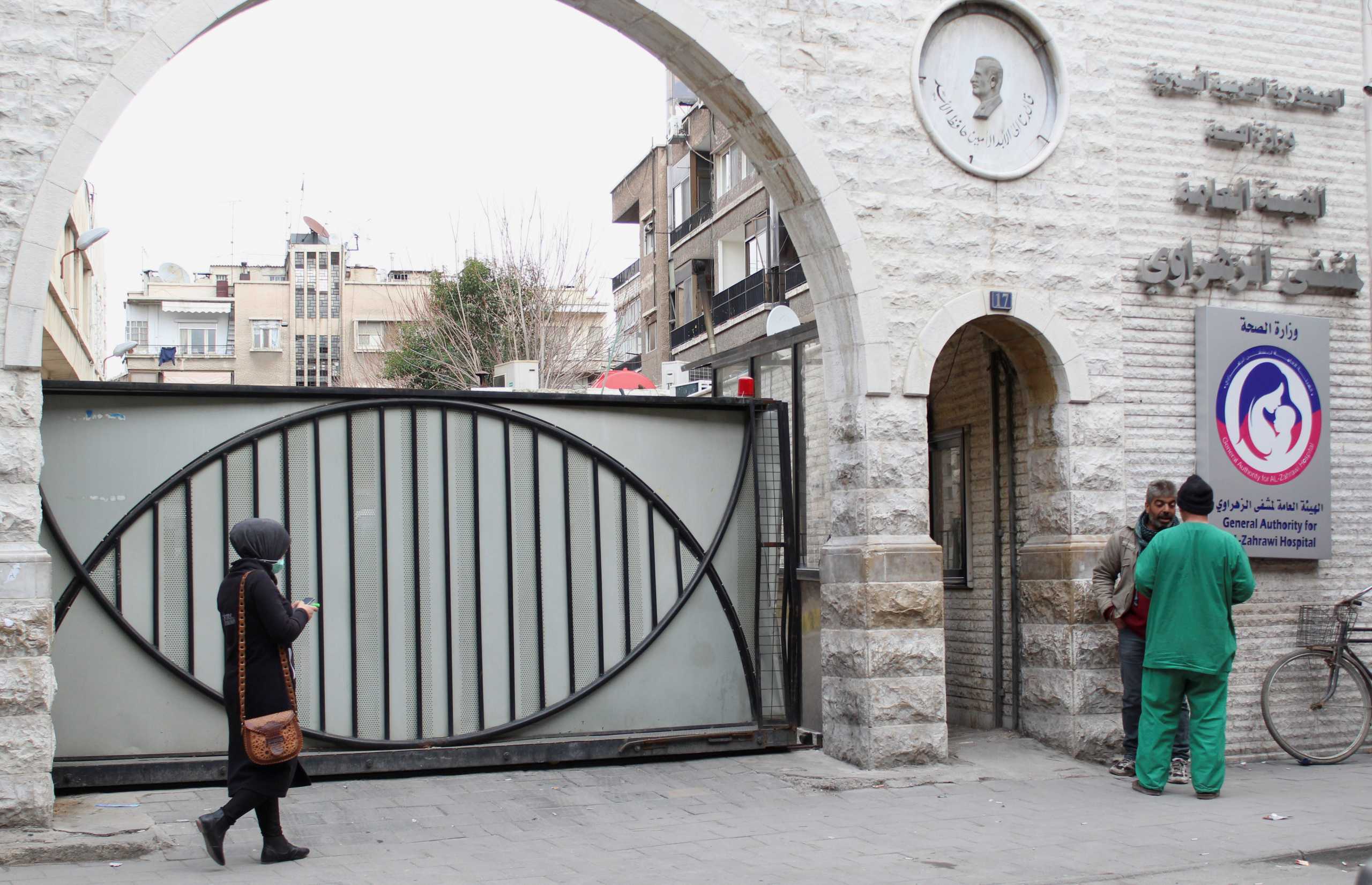 People stand outside a hospital in Damascus, amid concerns over the spread of the coronavirus disease (COVID-19), in Damascus, Syria March 3, 2021. Picture taken March 3, 2021. REUTERS