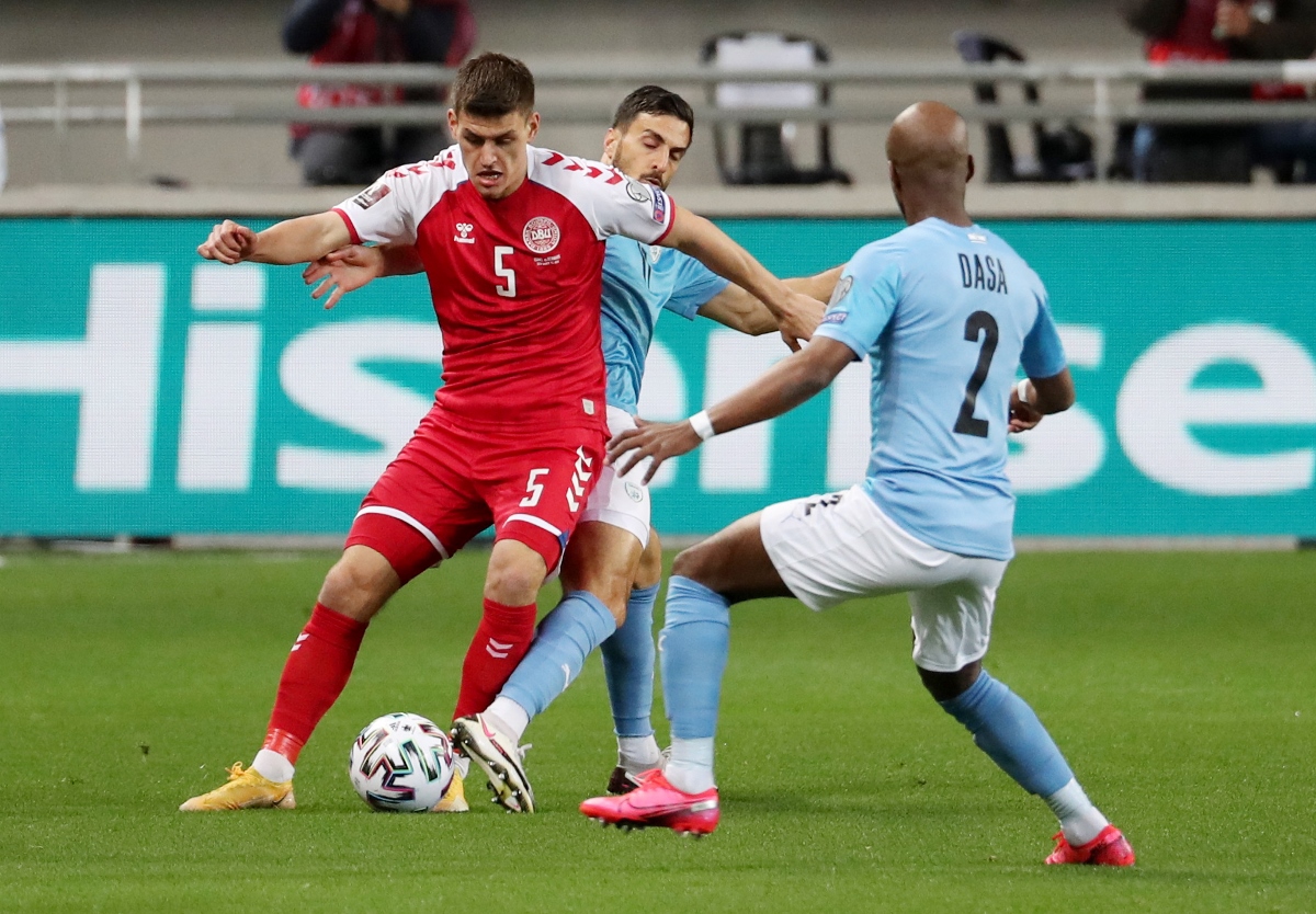 Soccer Football - World Cup Qualifiers Europe - Group F - Israel v Denmark - Bloomfield Stadium, Tel Aviv, Israel - March 25, 2021 Denmark's Joakim Maehle in action with Israel's Hatem Elhamed and Eli Dasa REUTERS
