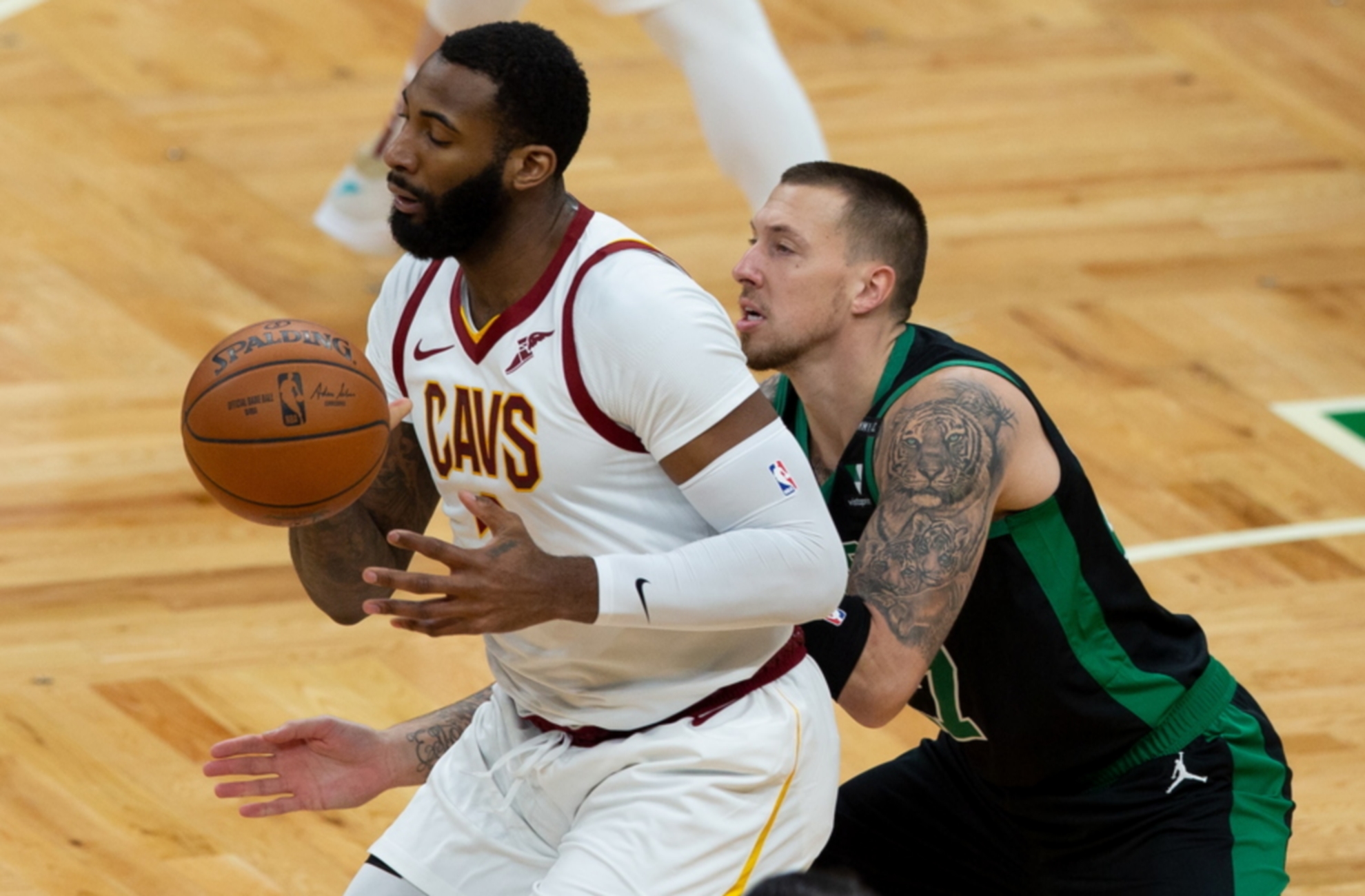 epa08963352 Boston Celtics center Daniel Theis (R) knocks the ball out of the hands of Cleveland Cavaliers center Andre Drummond (L) during the first quarter at the TD Garden in Boston, Massachusetts, USA, 24 January 2021.  EPA