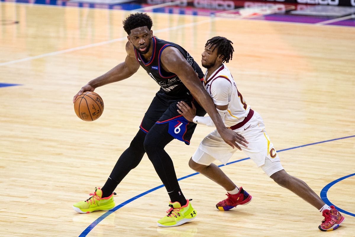 Feb 27, 2021; Philadelphia, Pennsylvania, USA; Philadelphia 76ers center Joel Embiid (21) dribbles against Cleveland Cavaliers guard Darius Garland (10) during the third quarter at Wells Fargo Center. Mandatory Credit: Bill Streicher-USA TODAY Sports