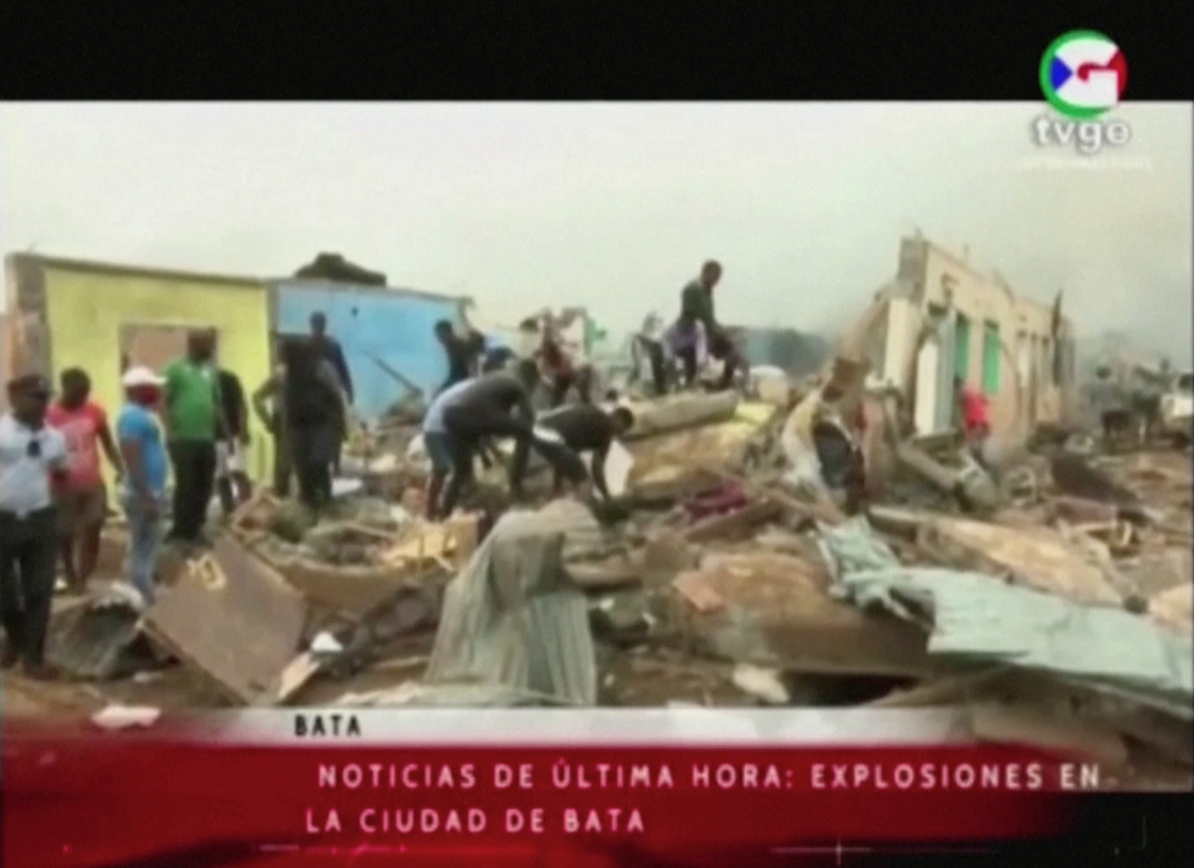 People search through rubble following explosions at a military base, according to local media, in Bata, Equatorial Guinea March 7, 2021. TVGE