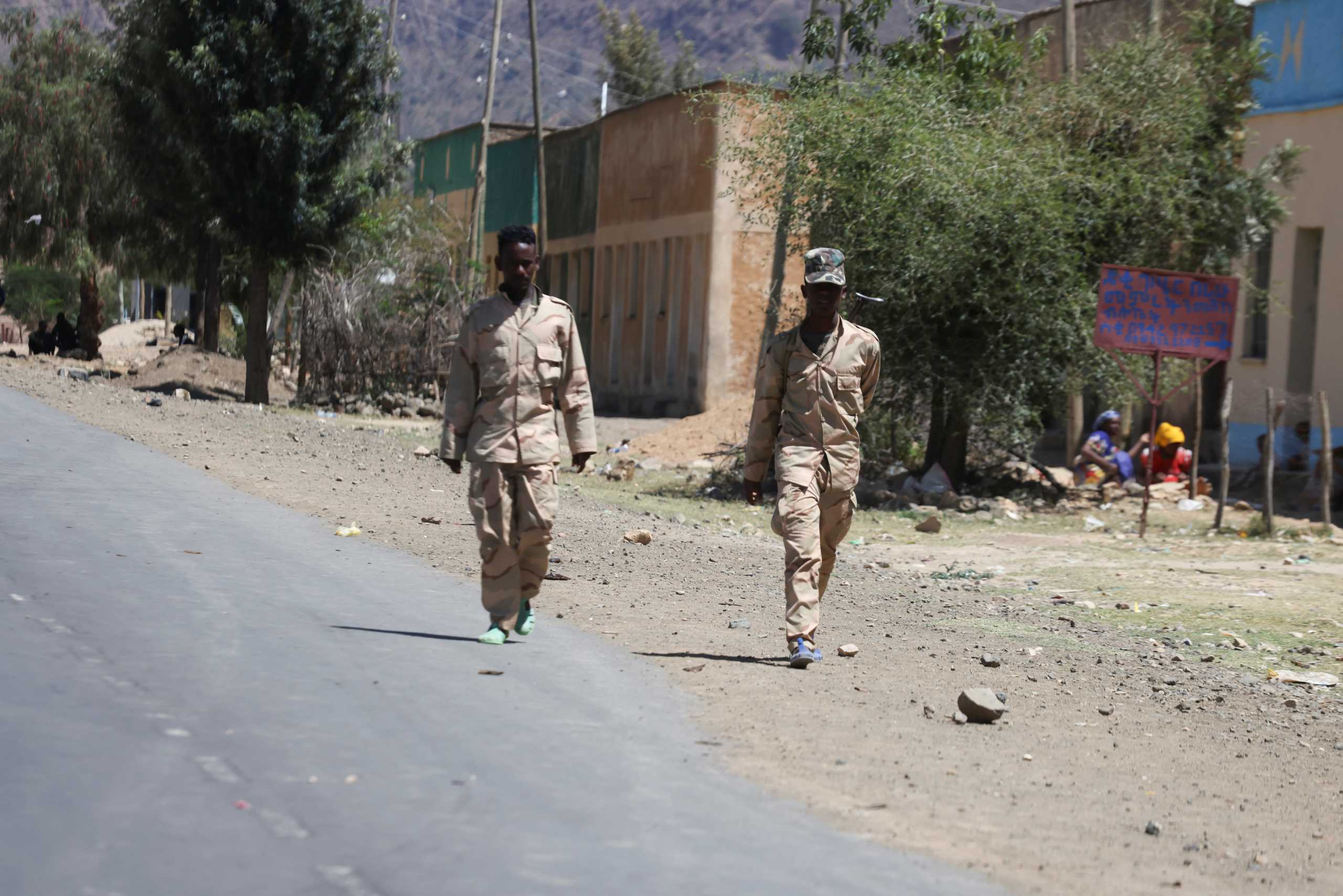 Troops in Eritrean uniforms walk near the town of Adigrat, Ethiopia, March 18, 2021.Picture taken March 18, 2021. REUTERS