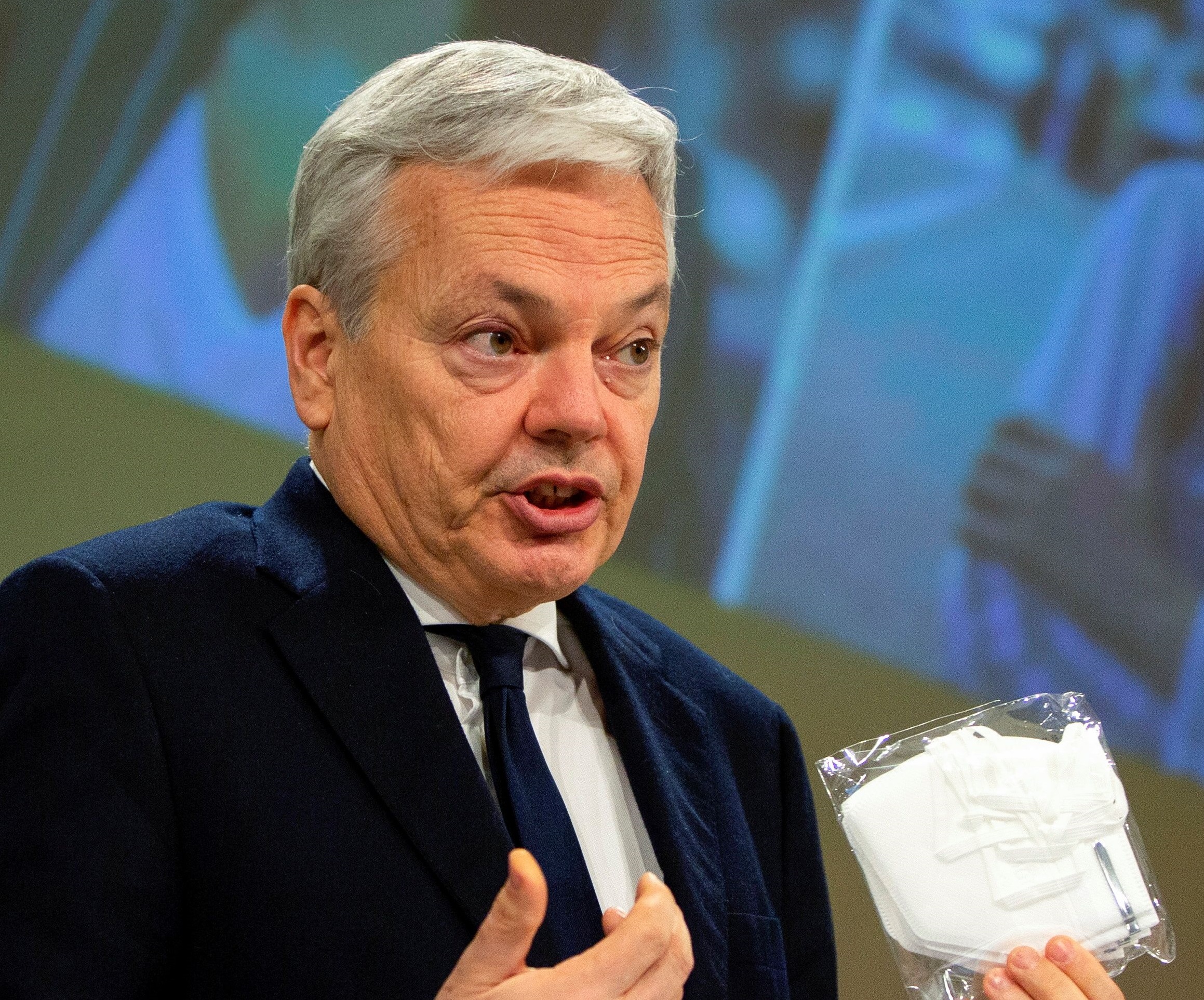 European Commissioner for Justice Didier Reynders holds up a package containing a protective face mask as he addresses a media conference on the Safety Gate rapid alert system for dangerous products at EU headquarters in Brussels, Belgium, March 2, 2021. Virginia Mayo