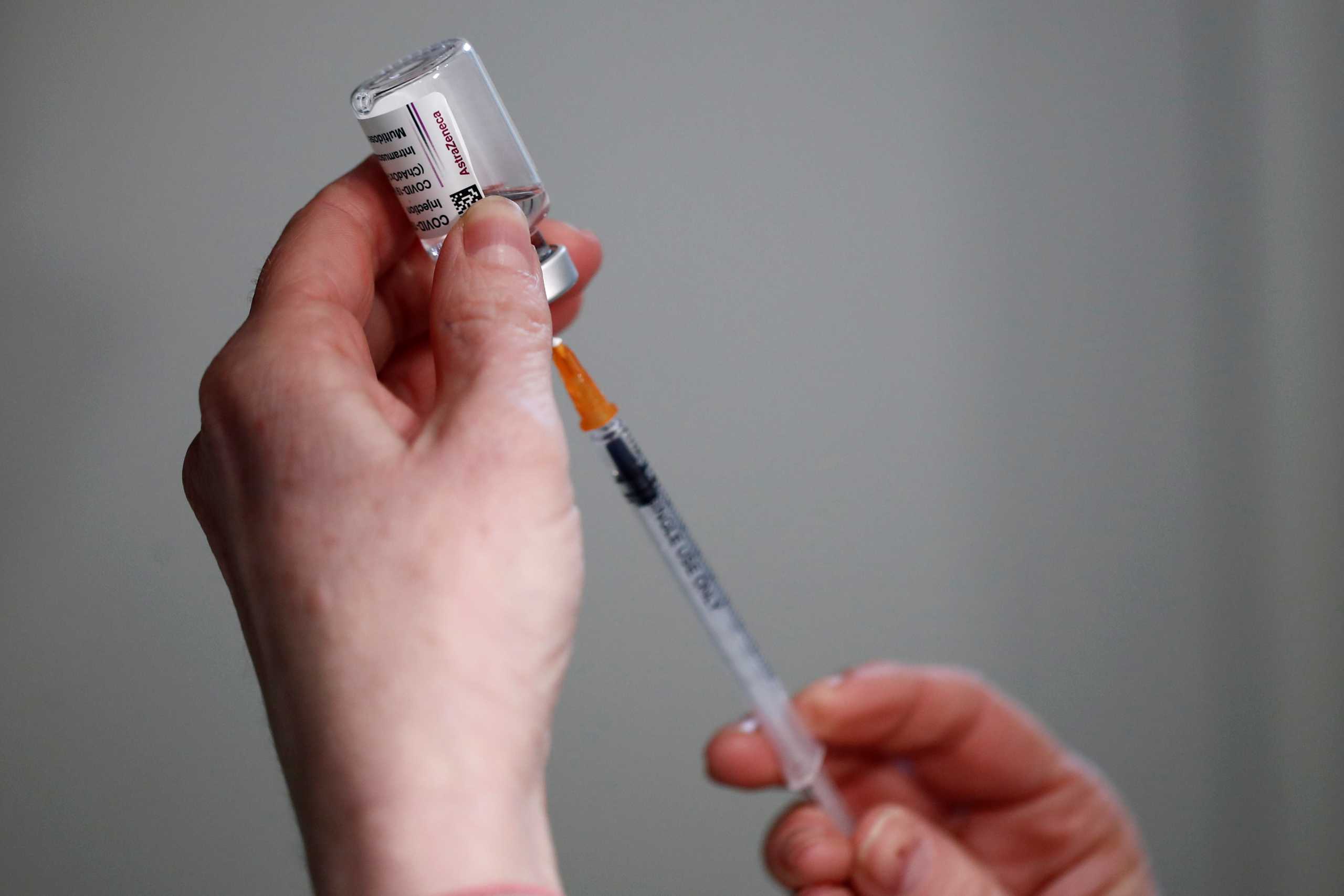 A pharmacist prepares a dose of the AstraZeneca COVID-19 vaccine in a pharmacy in Paris as part of the coronavirus disease (COVID-19) vaccination campaign in France, March 19, 2021. REUTERS