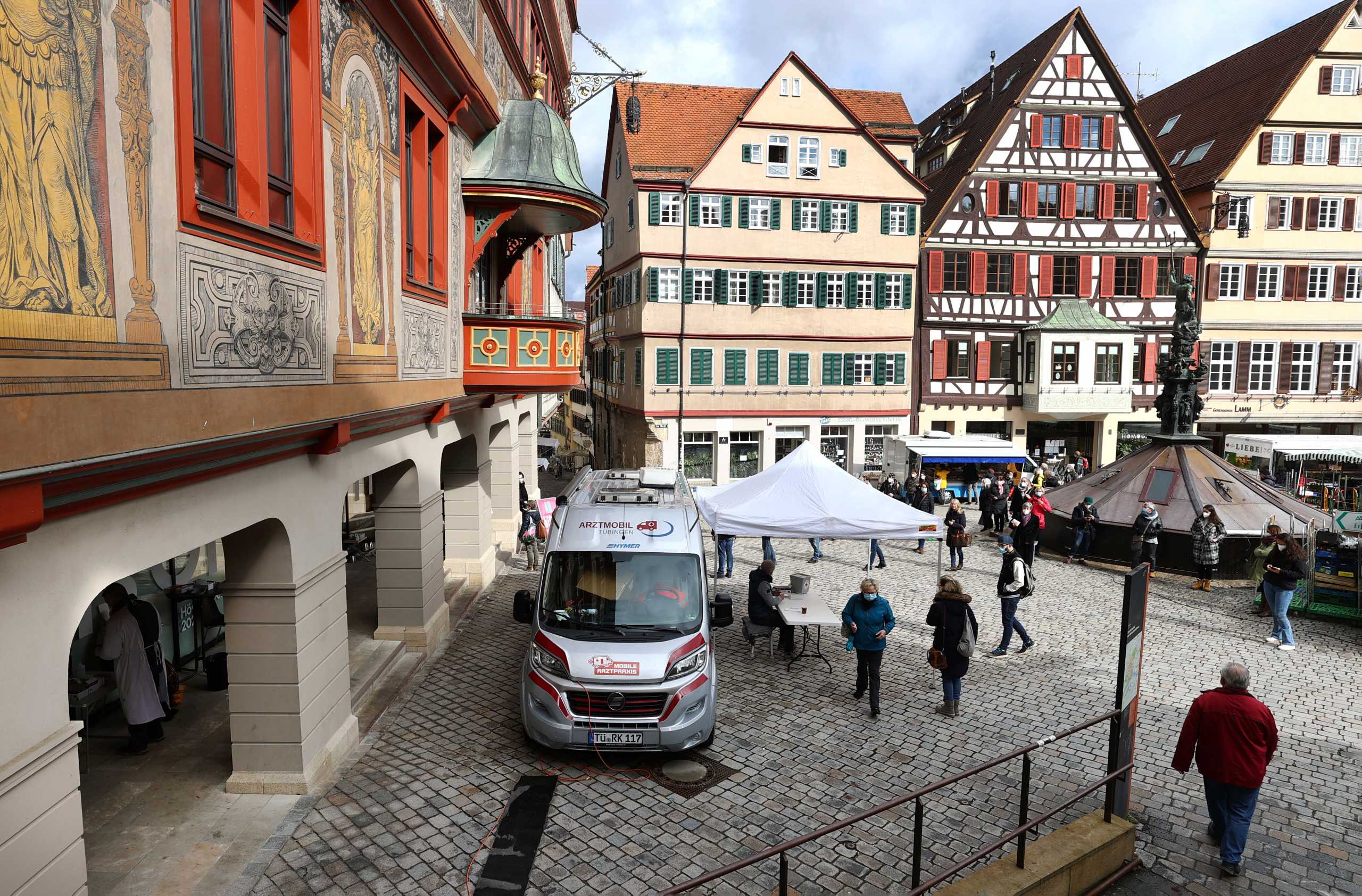 People queue outside a COVID-19 rapid test centre to get a day pass to visit shops and cultural institutions as the spread of the coronavirus disease (COVID-19) continues in Tuebingen, Germany, March 17, 2021.  REUTERS