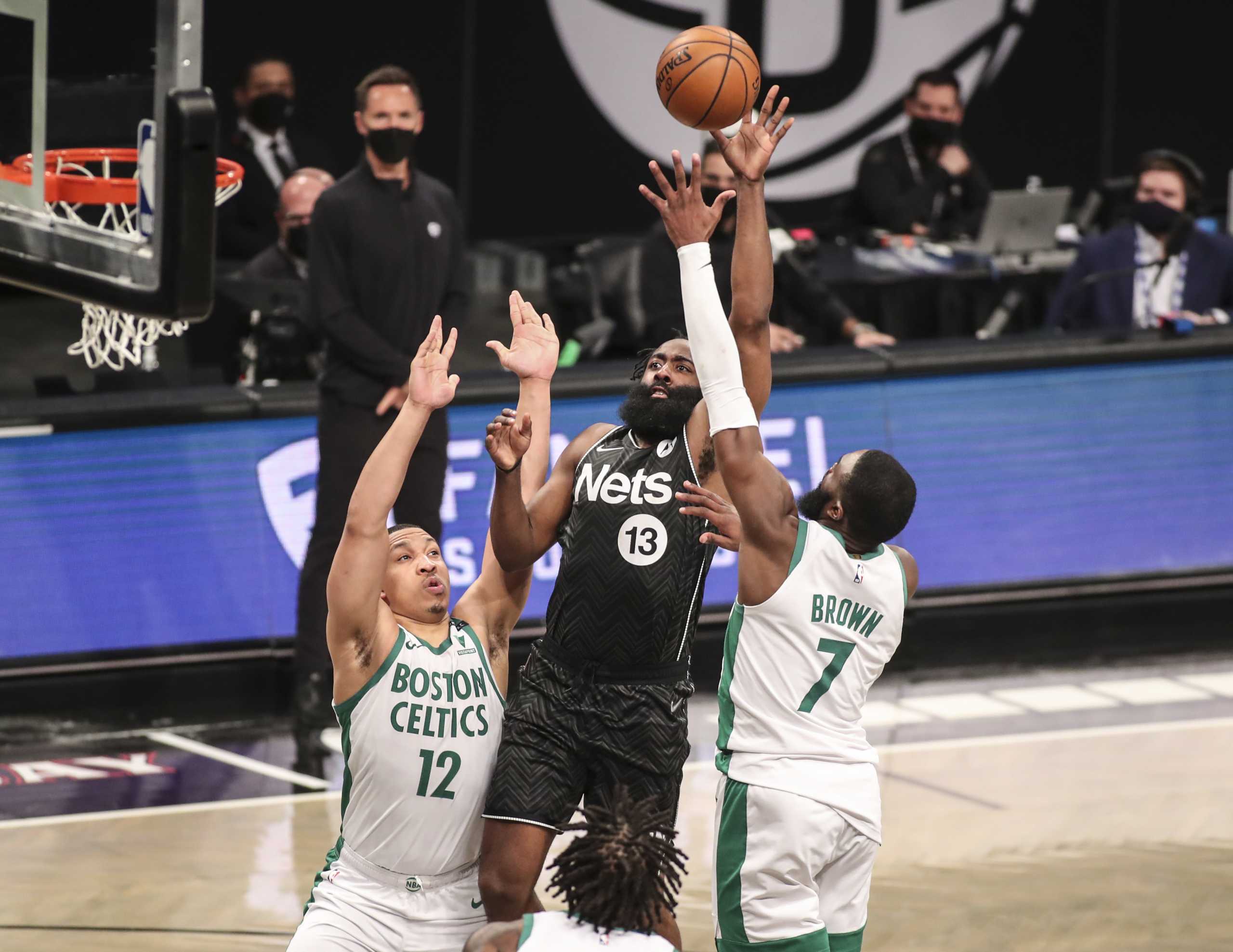 Mar 11, 2021; Brooklyn, New York, USA; Brooklyn Nets guard James Harden (13) shoots over Boston Celtics forward Grant Williams (12) and guard Jaylen Brown (7) in the fourth quarter at Barclays Center. Mandatory Credit: Wendell Cruz-USA TODAY Sports