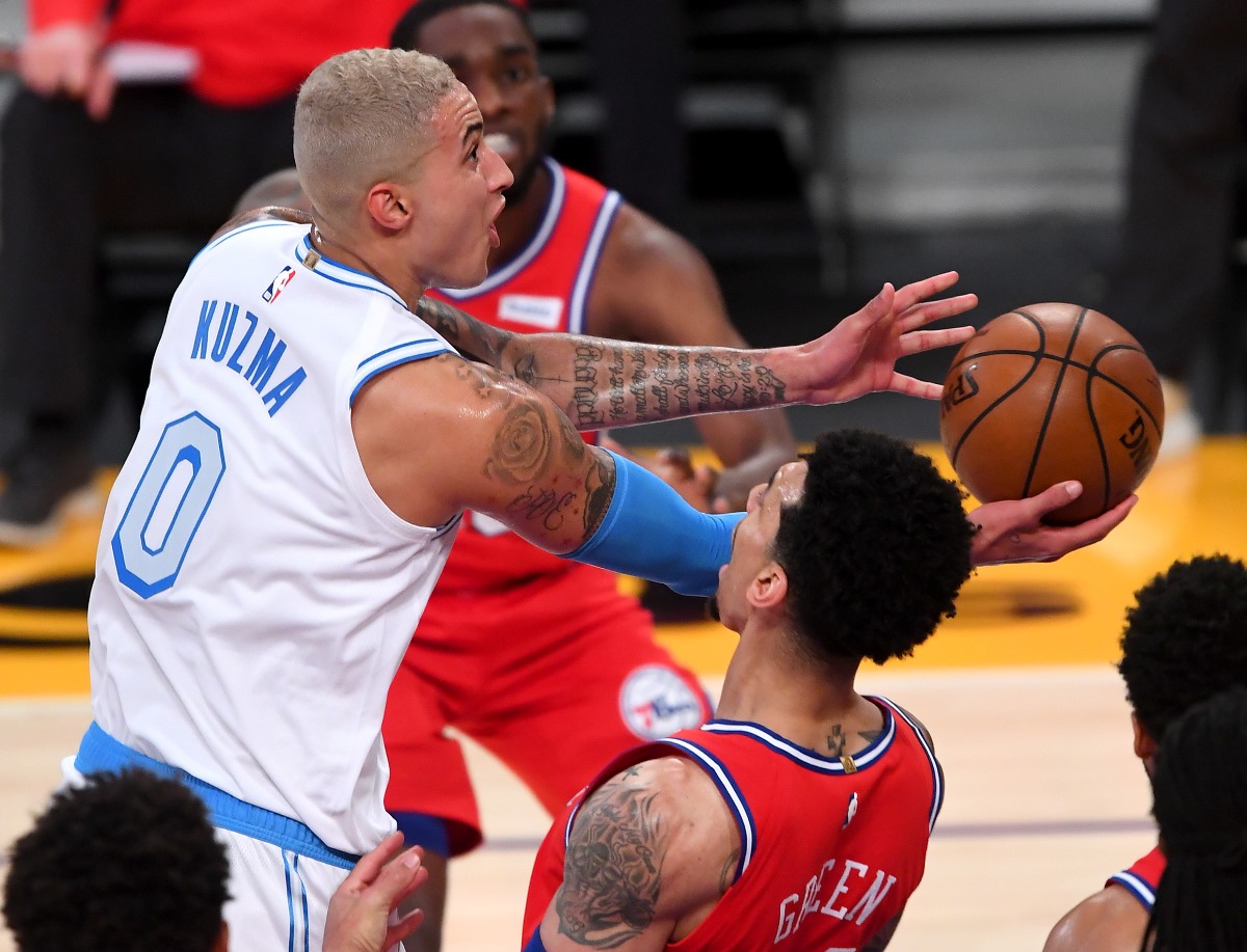 Mar 25, 2021; Los Angeles, California, USA;  Los Angeles Lakers forward Kyle Kuzma (0) gets past Philadelphia 76ers forward Danny Green (14) for a basket in the second half of the game at Staples Center. Mandatory Credit: Jayne Kamin-Oncea-USA TODAY Sports