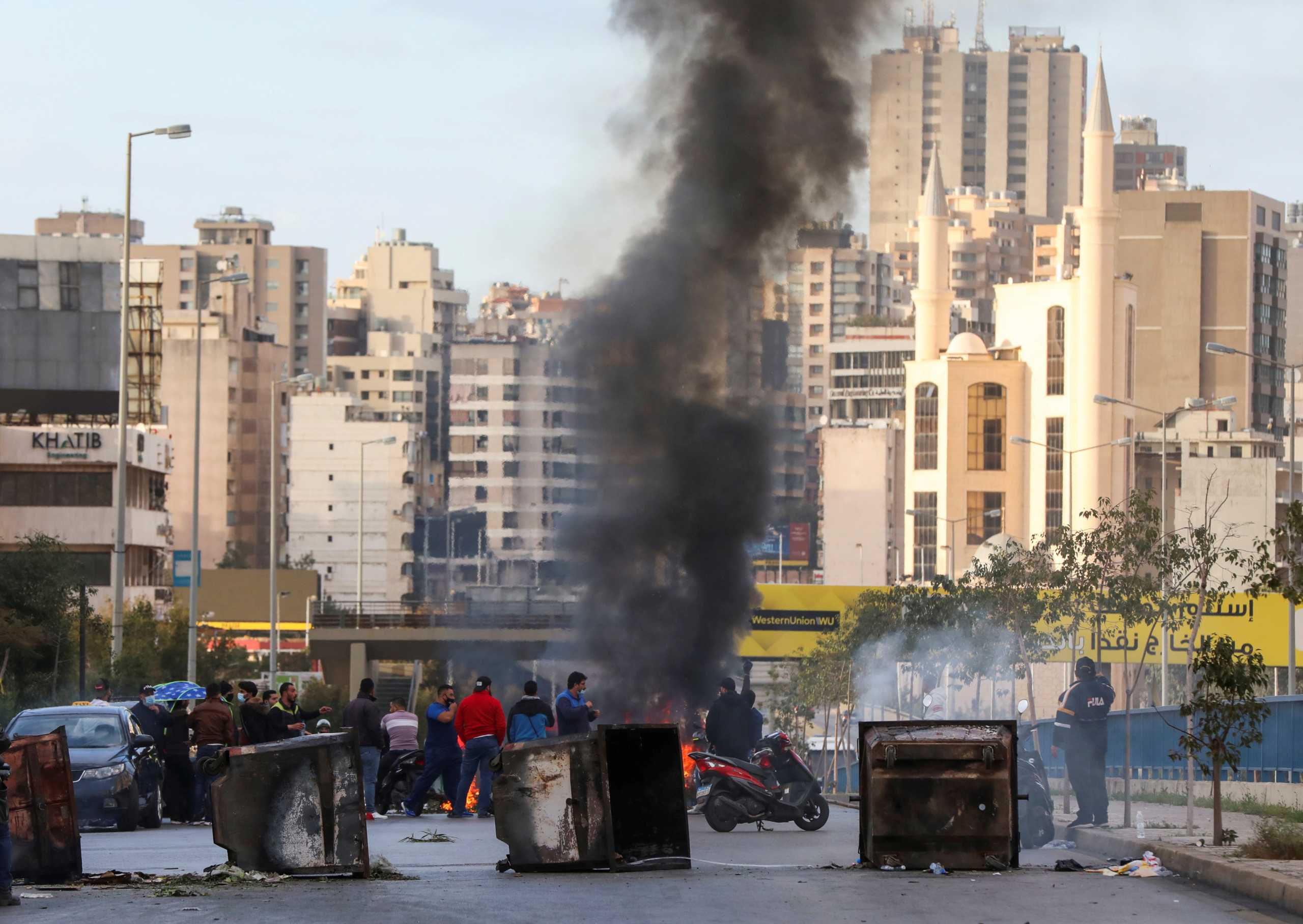 FILE PHOTO: Demonstrators block a road with garbage bins, during a protest against the fall in Lebanese pound currency and mounting economic hardships, in Beirut, Lebanon March 16, 2021. REUTERS
