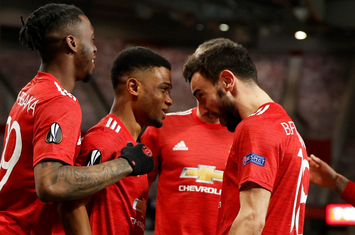 Soccer Football - Europa League - Round of 16 First Leg - Manchester United v AC Milan - Old Trafford, Manchester, Britain - March 11, 2021 Manchester United's Amad Diallo celebrates scoring their first goal with teammates REUTERS