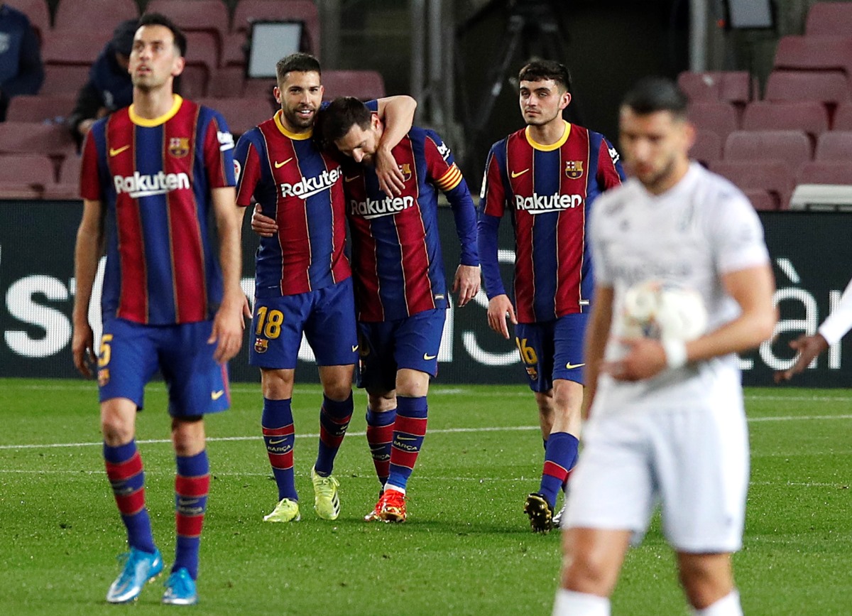 Soccer Football - La Liga Santander - FC Barcelona v SD Huesca - Camp Nou, Barcelona, Spain - March 15, 2021 Barcelona's Lionel Messi celebrates scoring their first goal with Jordi Alba REUTERS