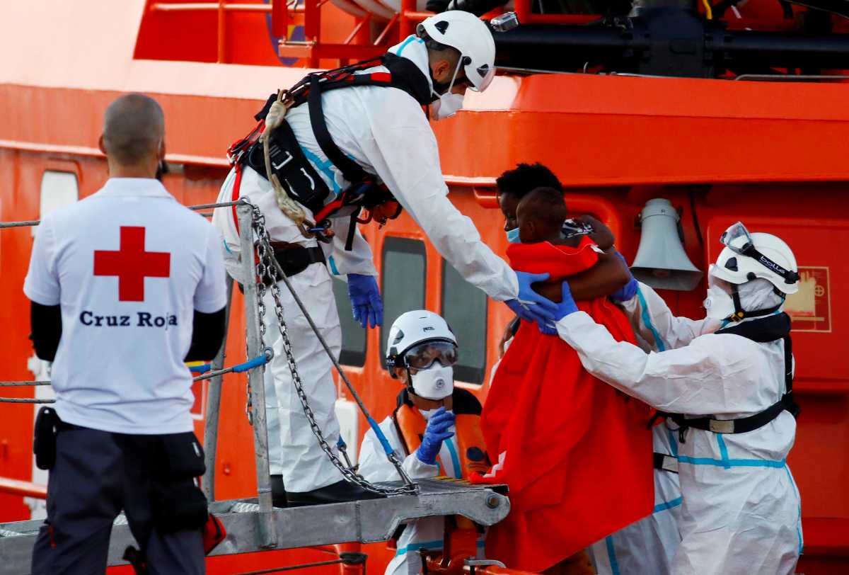FILE PHOTO: A migrant disembarks a Spanish coast guard vessel, in the port of Arguineguin, in the south part of the island of Gran Canaria, Spain March 17, 2021. REUTERS