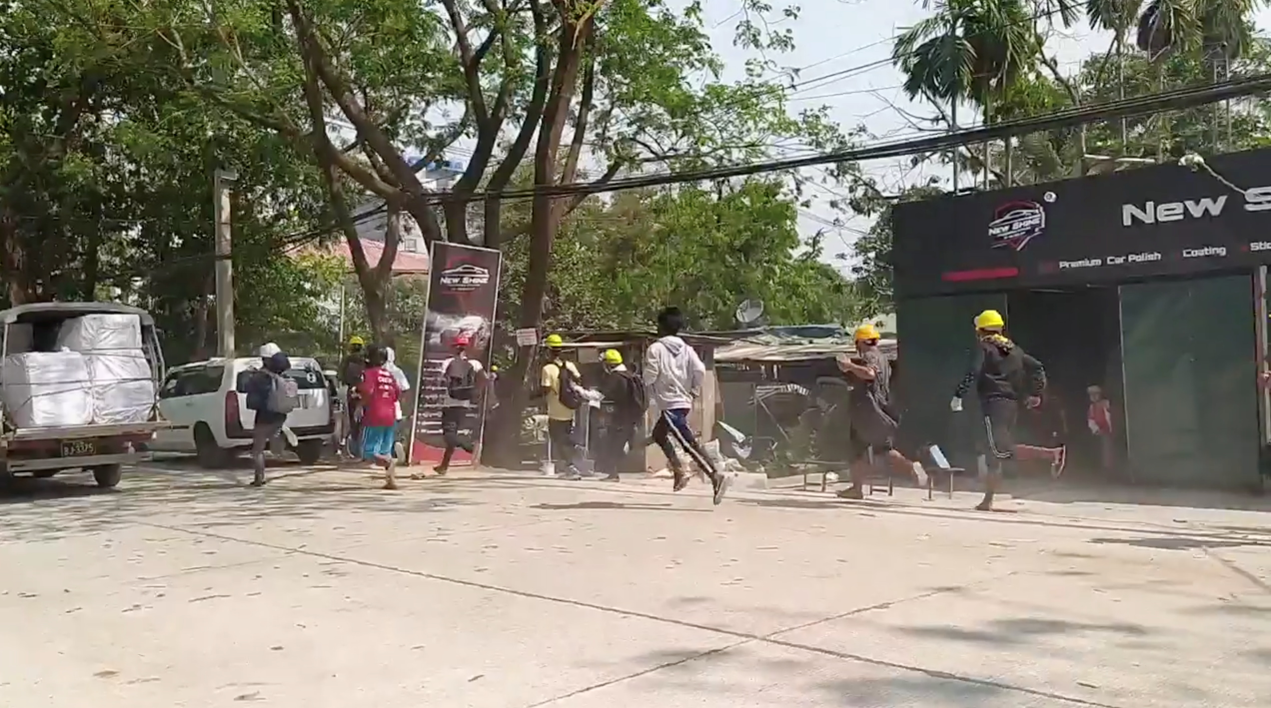 People flee away to safety during a protest in Yangon, Myanmar March 10, 2021 in this still image obtained by Reuters from a social media video.  ATTENTION EDITORS - THIS IMAGE HAS BEEN SUPPLIED BY A THIRD PARTY.  NO RESALES. NO ARCHIVES.