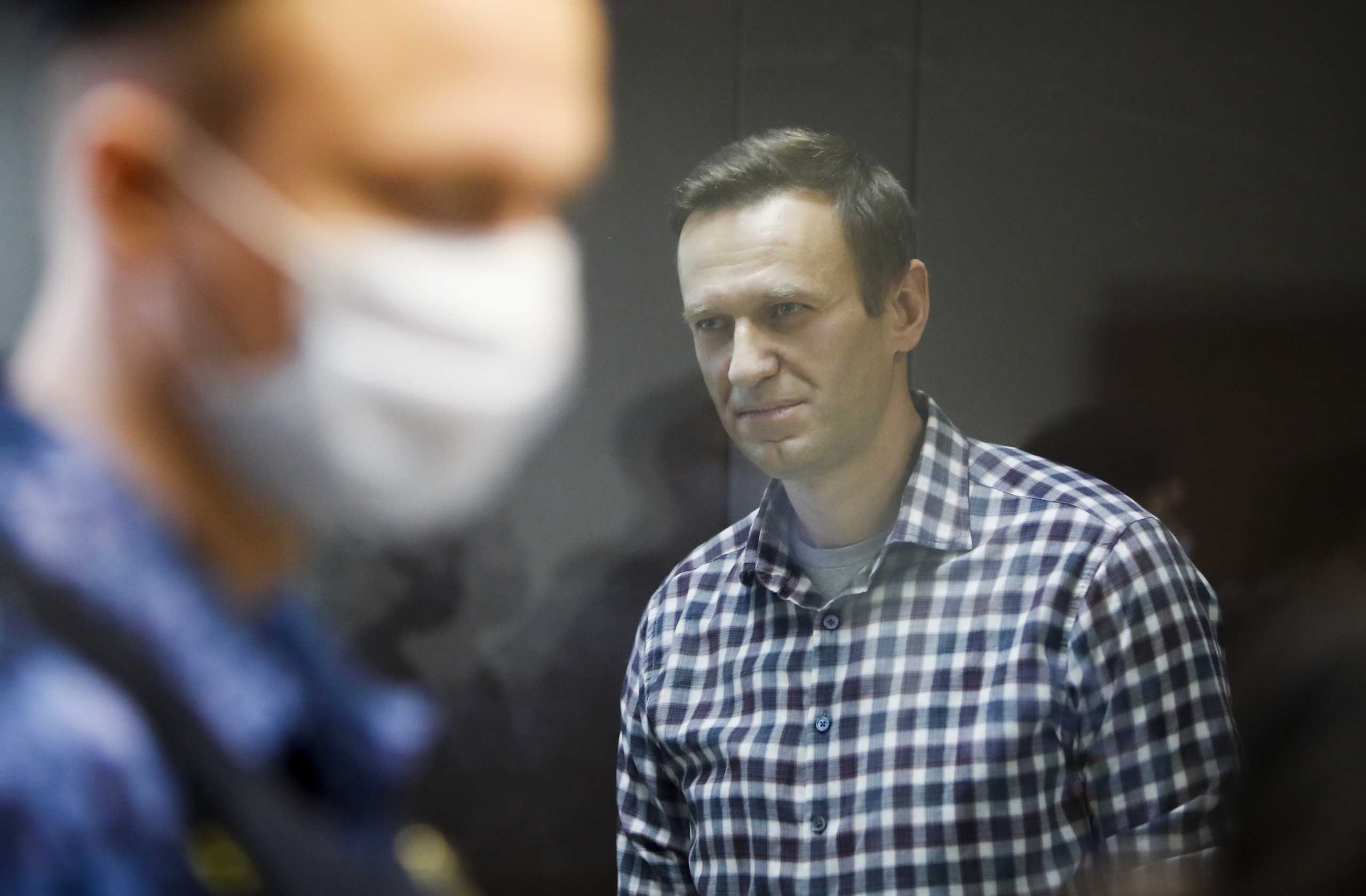 FILE PHOTO: Russian opposition politician Alexei Navalny attends a hearing to consider an appeal against an earlier court decision to change his suspended sentence to a real prison term, in Moscow, Russia February 20, 2021. REUTERS