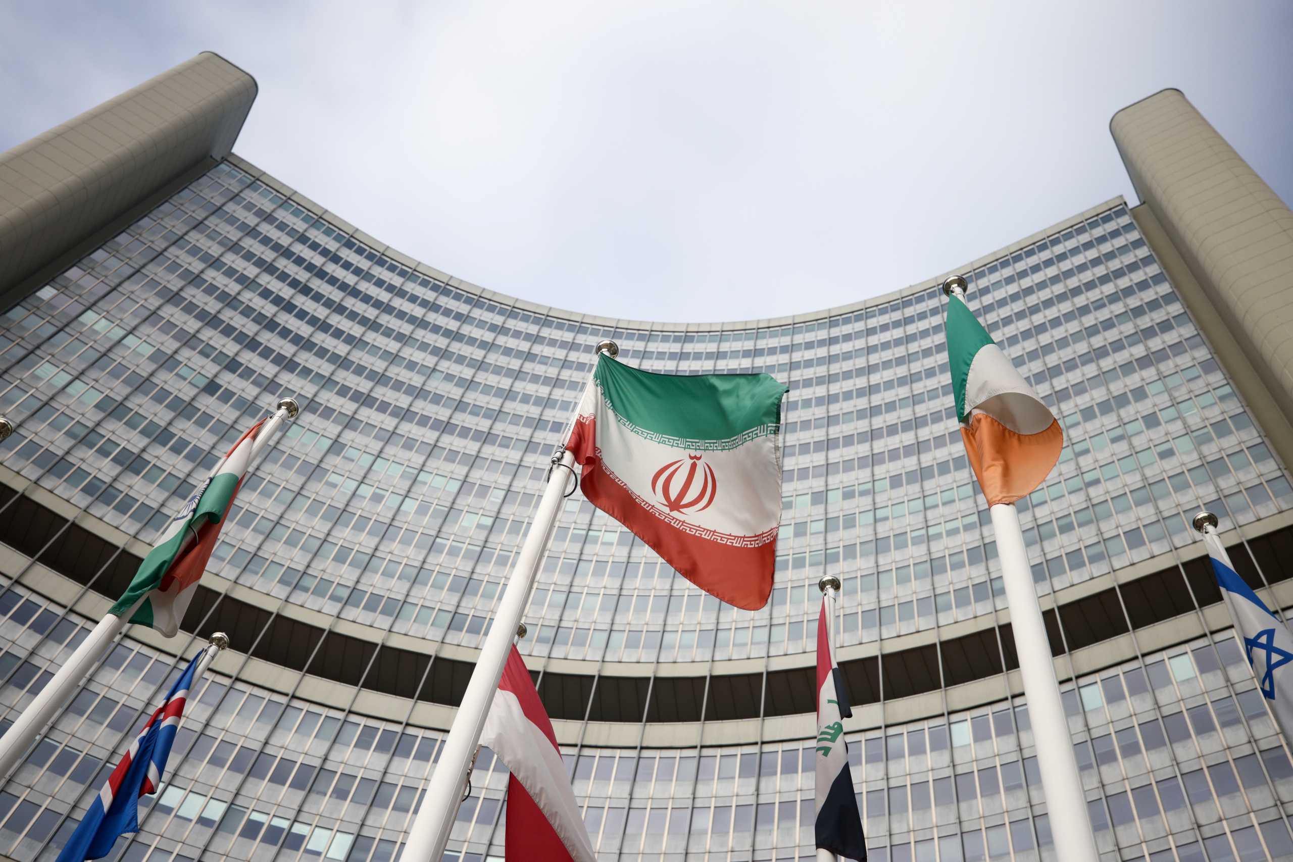 The Iranian flag waves in front of the International Atomic Energy Agency (IAEA) headquarters, amid the coronavirus disease (COVID-19) outbreak in Vienna, Austria, March 1, 2021. REUTERS
