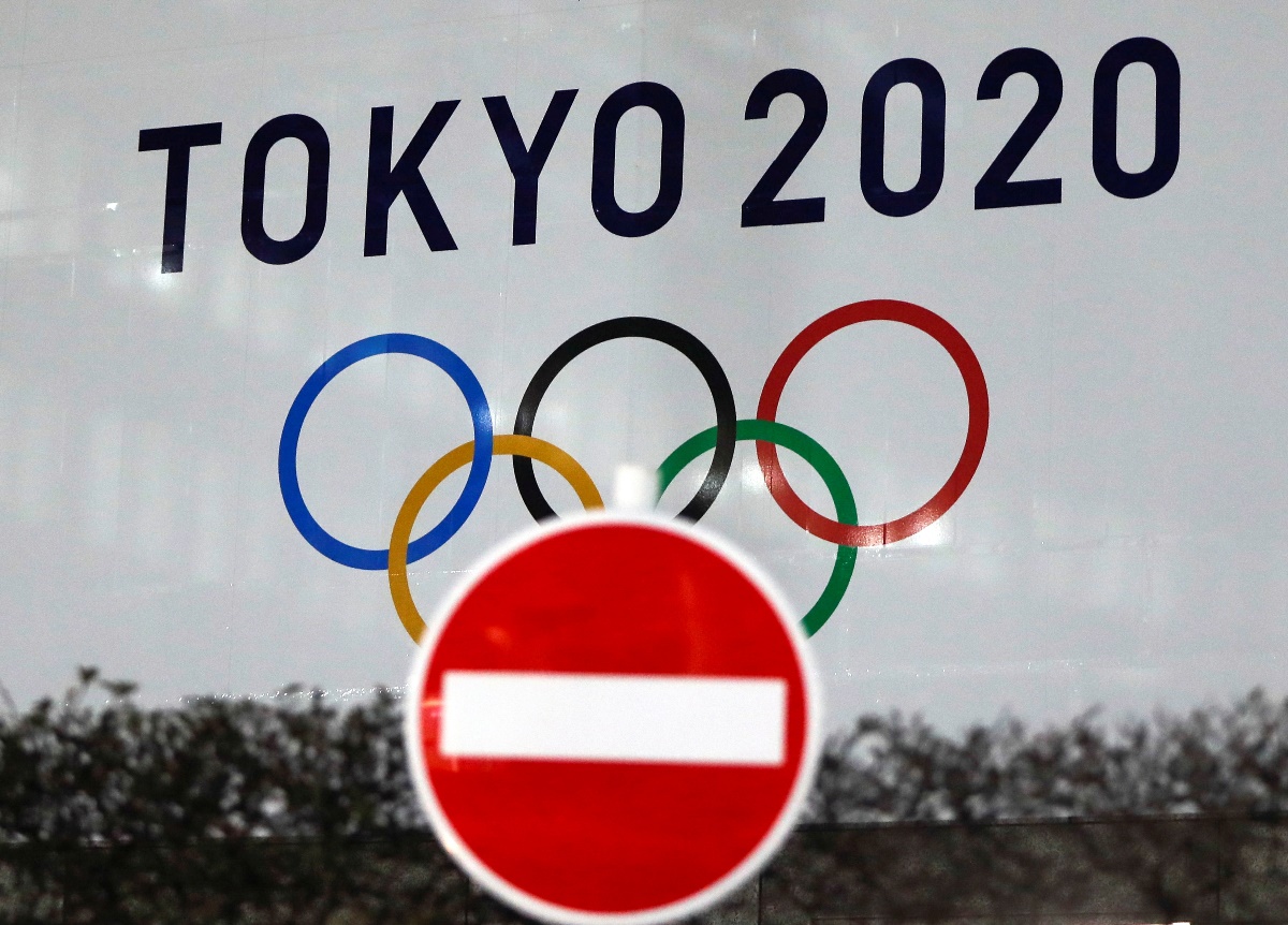 FILE PHOTO: The logo of Tokyo 2020 Olympic Games that have been postponed to 2021 due to the coronavirus disease (COVID-19) outbreak, is seen through a traffic sign at Tokyo Metropolitan Government Office building in Tokyo, Japan January 22, 2021. REUTERS