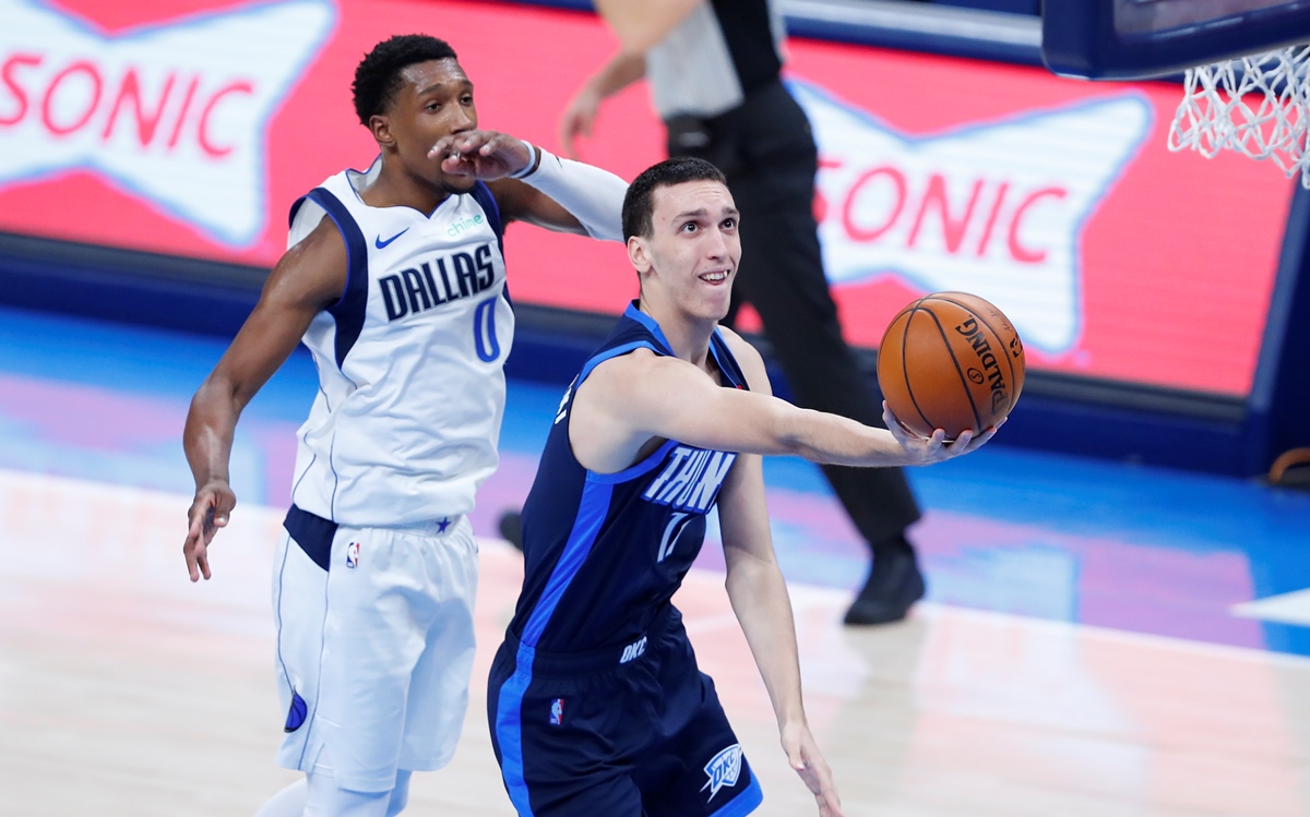 Mar 11, 2021; Oklahoma City, Oklahoma, USA; Oklahoma City Thunder forward Aleksej Pokusevski (17) drives to the basket against Dallas Mavericks guard Josh Richardson (0) during the second quarter at Chesapeake Energy Arena. Mandatory Credit: Alonzo Adams-USA TODAY Sports